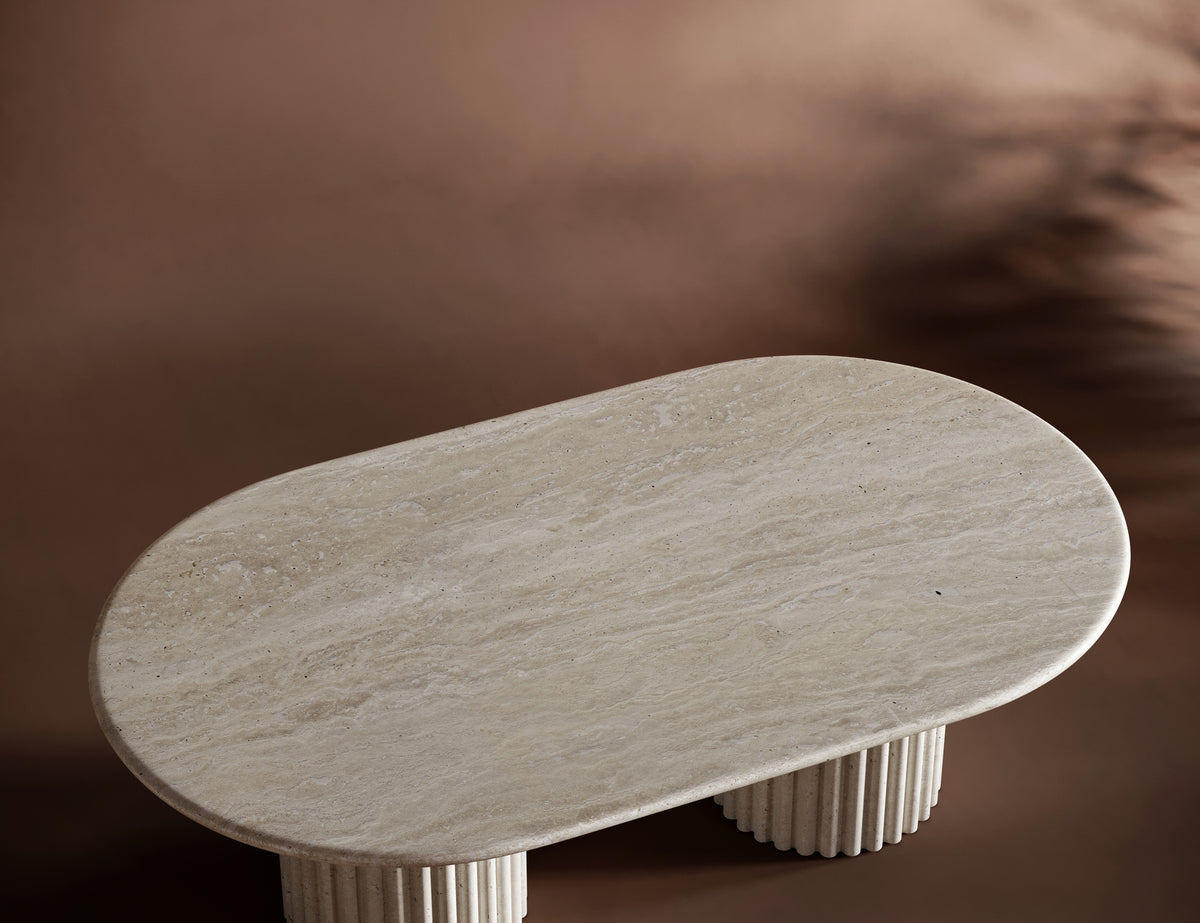 Handcrafted travertine coffee table with fluted bases and a smooth, elegant tabletop.