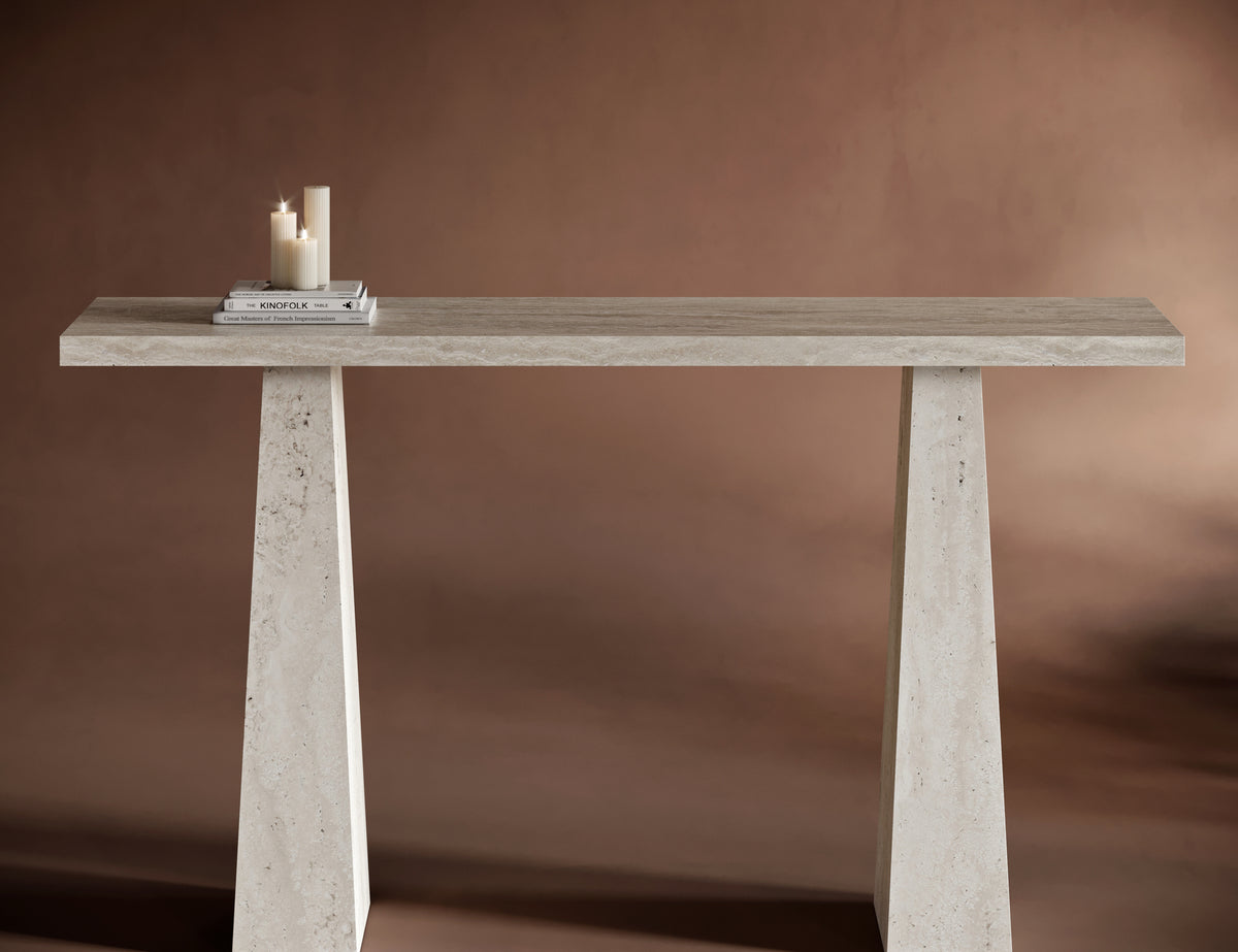 Close-up of ALESSIO travertine console table’s trapezoidal legs and natural stone texture.