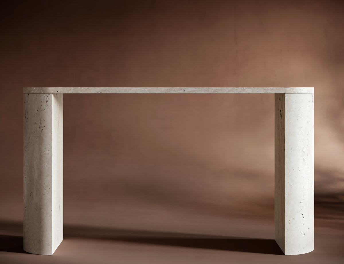 Handcrafted travertine console table with oval-shaped top and sculptural design.