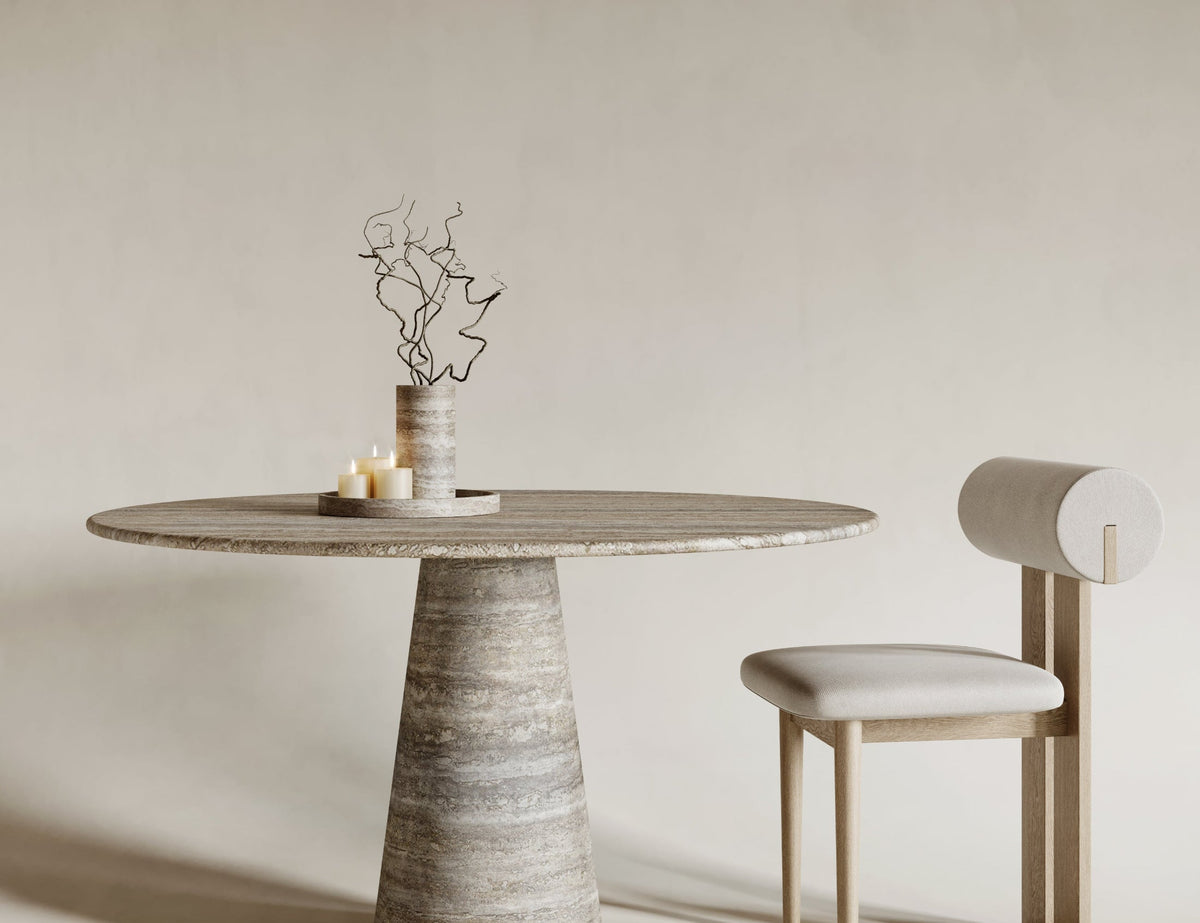 Round silver travertine dining table featuring conical leg design, sleek modern travertin form, natural stone elegance, ideal for contemporary dining, sculptural stone craftsmanship