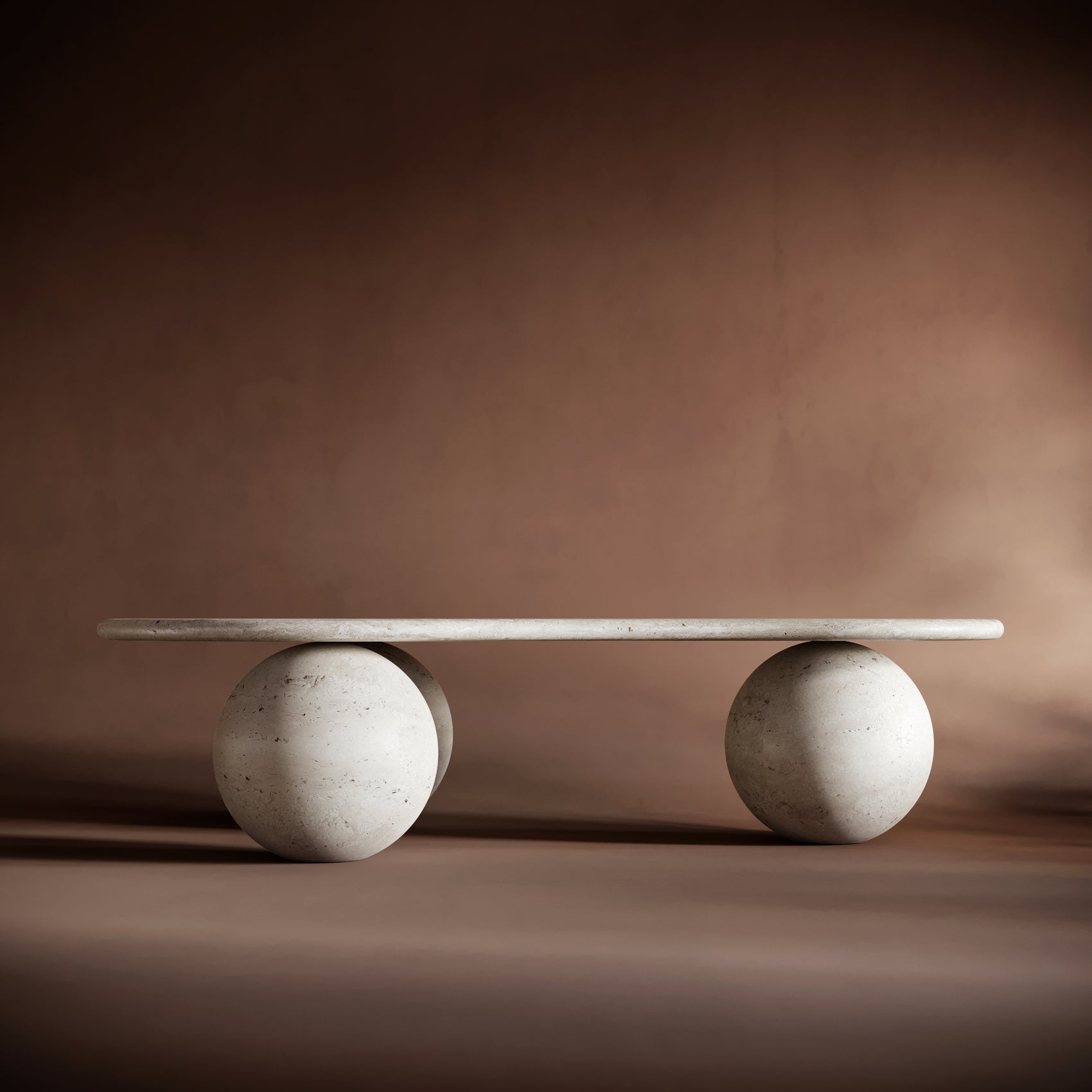 Handcrafted organic travertine coffee table with a flowing, undulating design and sculptural ball-shaped legs.