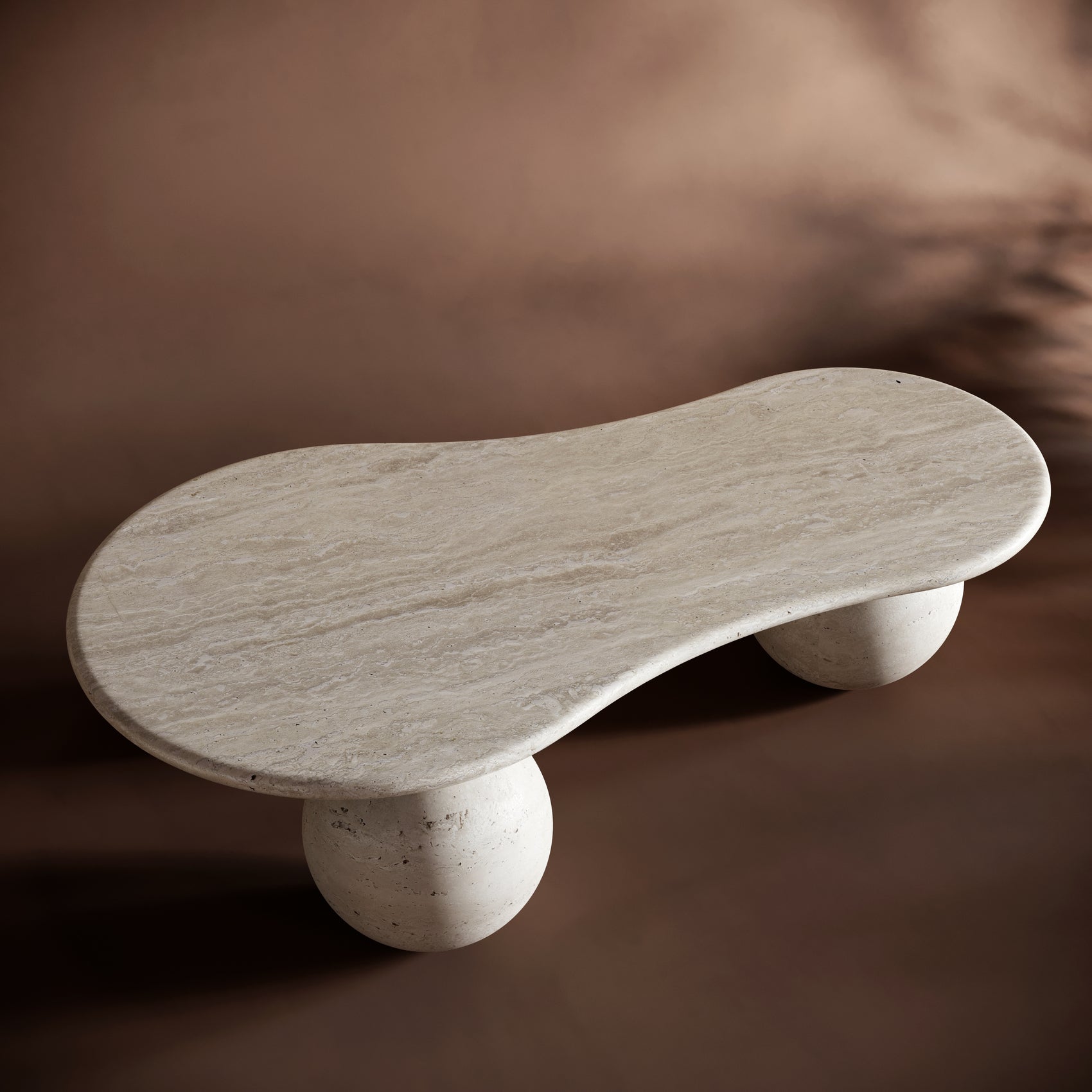 Minimalist interior featuring the MARCO travertine coffee table can br styled with books and warm lighting.