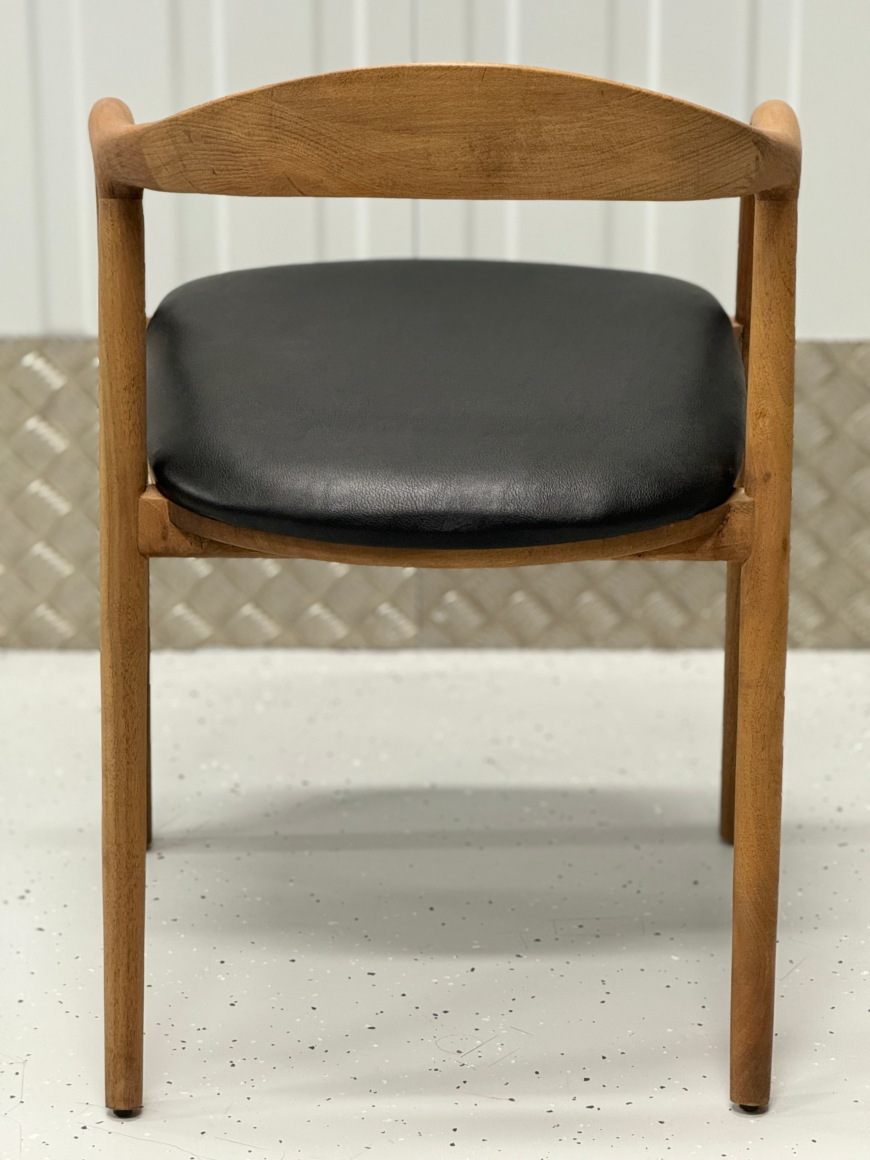 Beechwood dining chair with a curved backrest and solid frame, combining practicality with refined design.