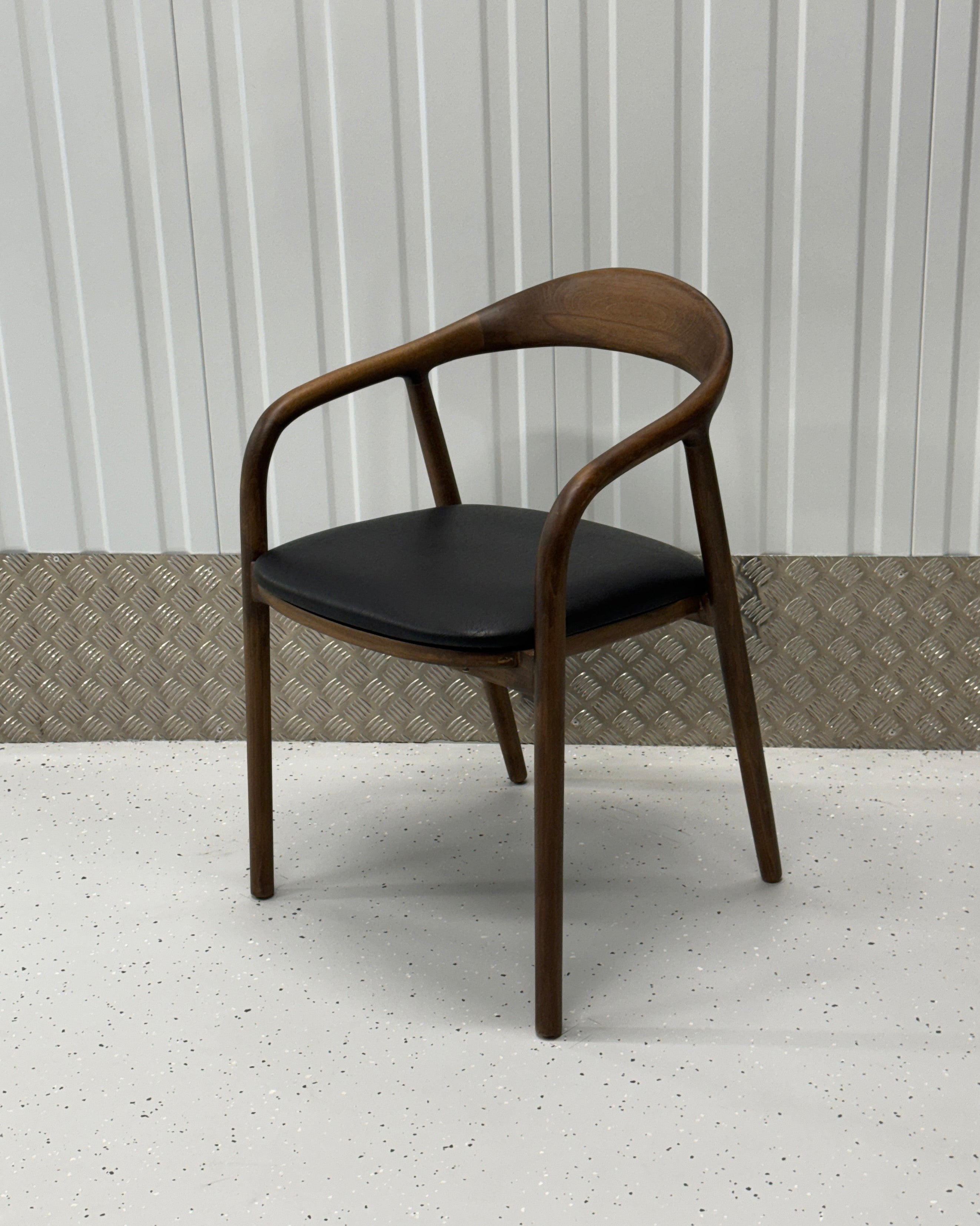 Handcrafted beechwood dining chair with a minimalist silhouette and smooth, polished finish, perfect for modern interiors.