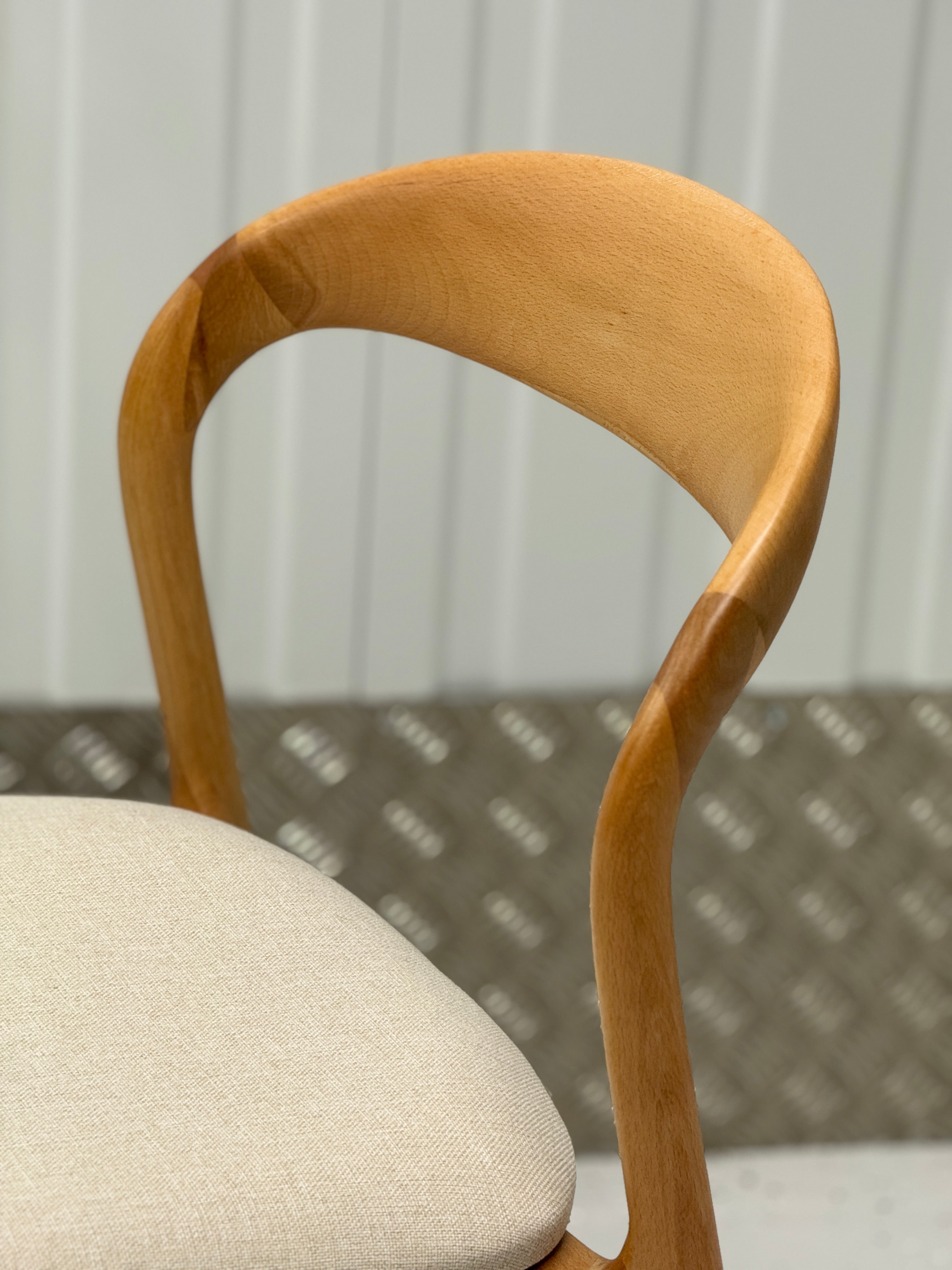 N-Light Chair showcasing elegant craftsmanship, curved lines, and a solid wood frame for lasting comfort and style