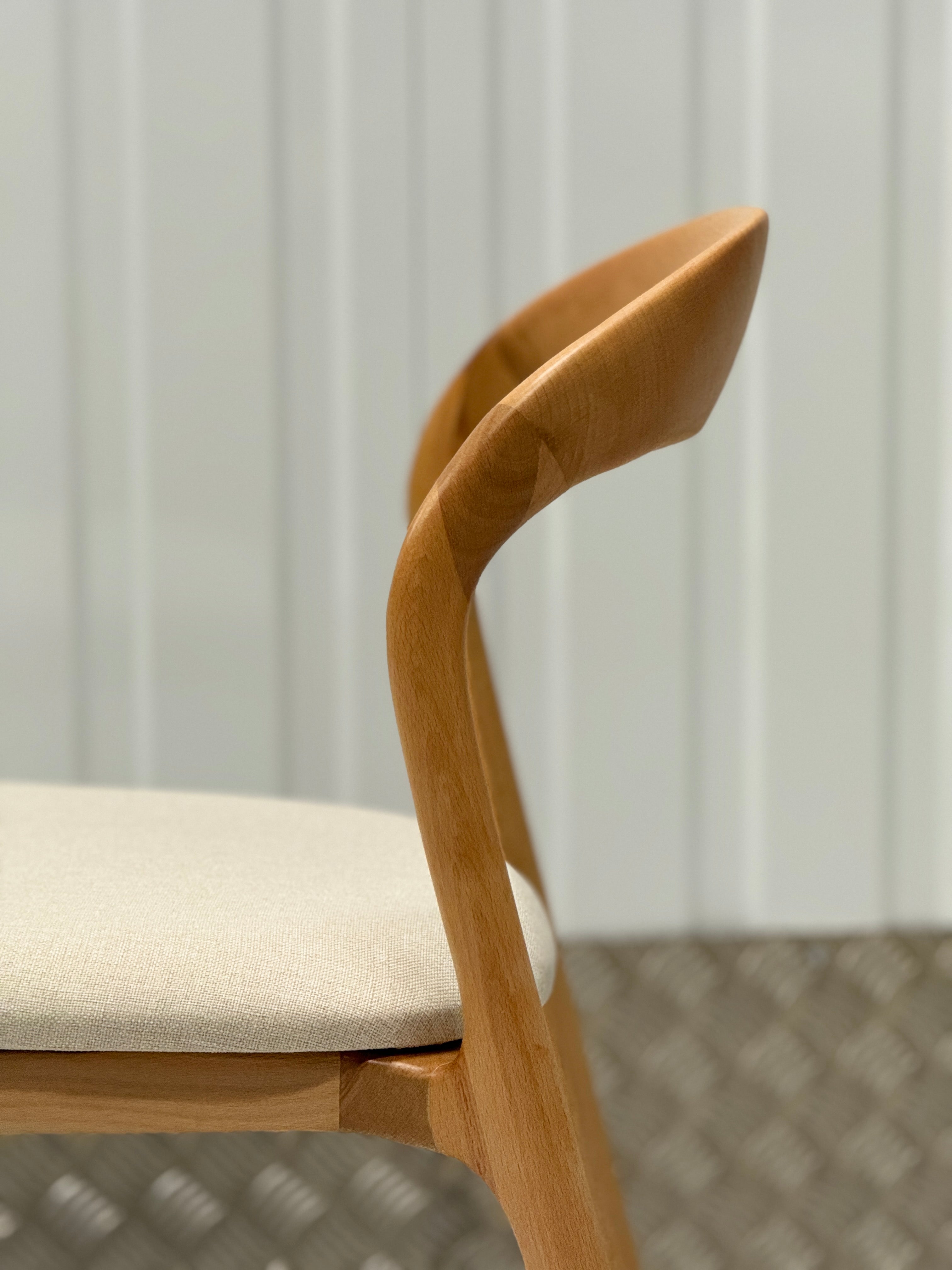 Modern dining chair with a sleek, handcrafted design, blending seamlessly into both contemporary and traditional interiors