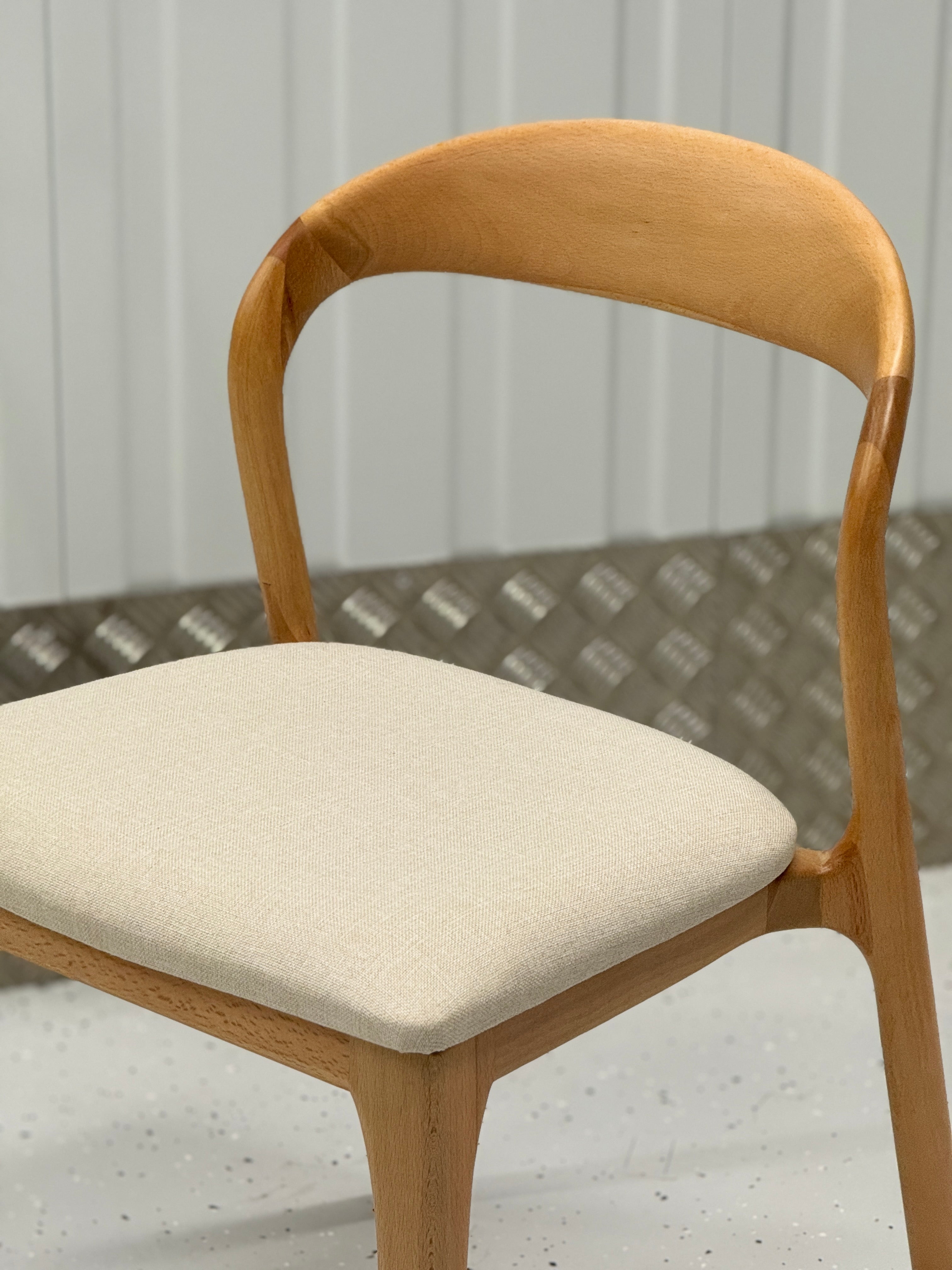 Versatile N-Light Chair with a minimalist profile and durable wooden frame, perfect for daily meals or formal gatherings