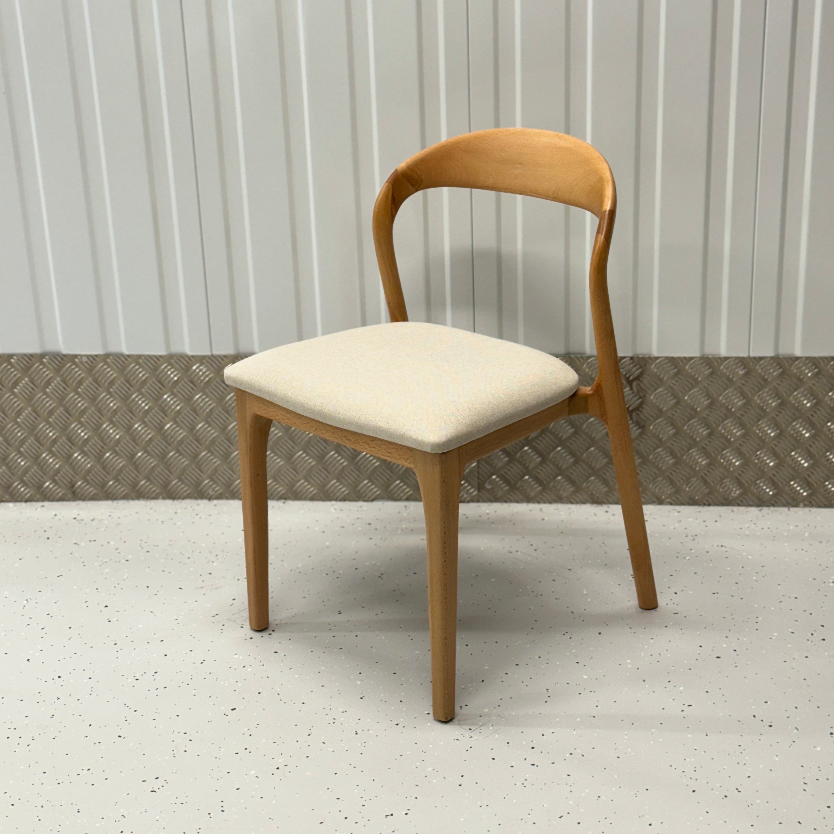 N-Light Chair with a solid wood structure and curved backrest, designed to complement modern and classic home decor styles