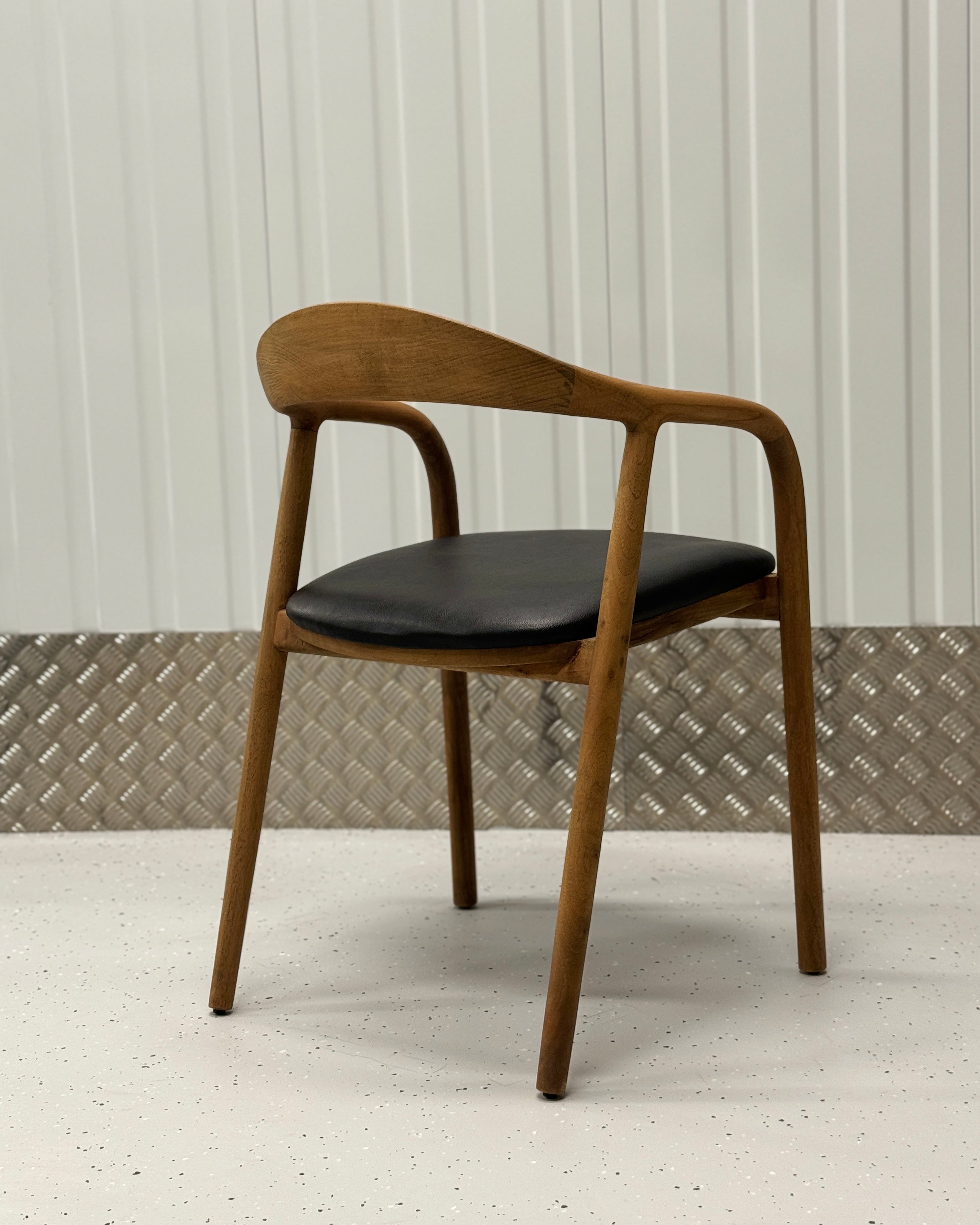 Handcrafted oak dining chair featuring a minimalist profile and durable construction, perfect for versatile home interiors.
