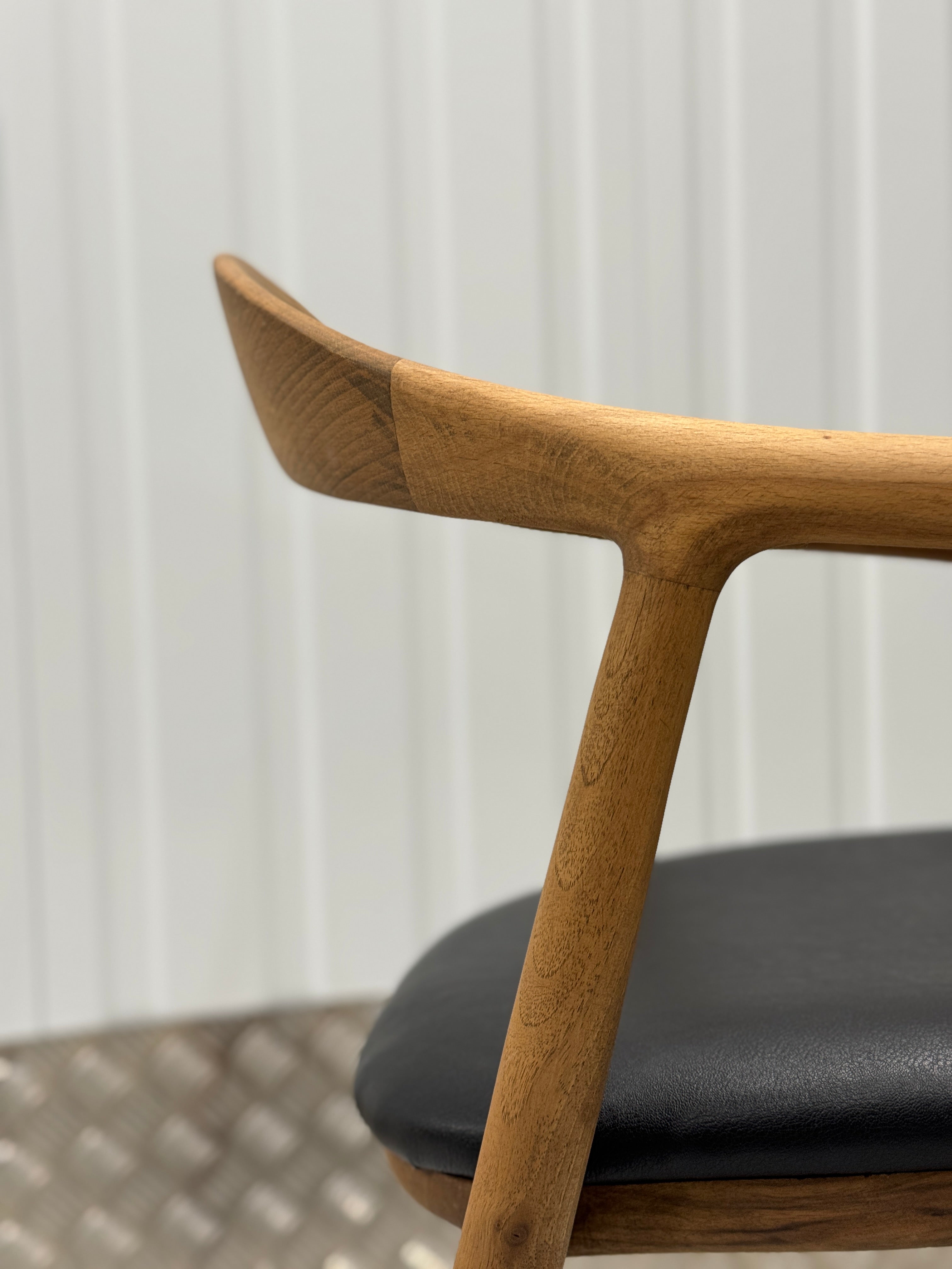Durable wooden dining chair made from premium oak, showcasing elegant craftsmanship and a sleek, minimalist silhouette.