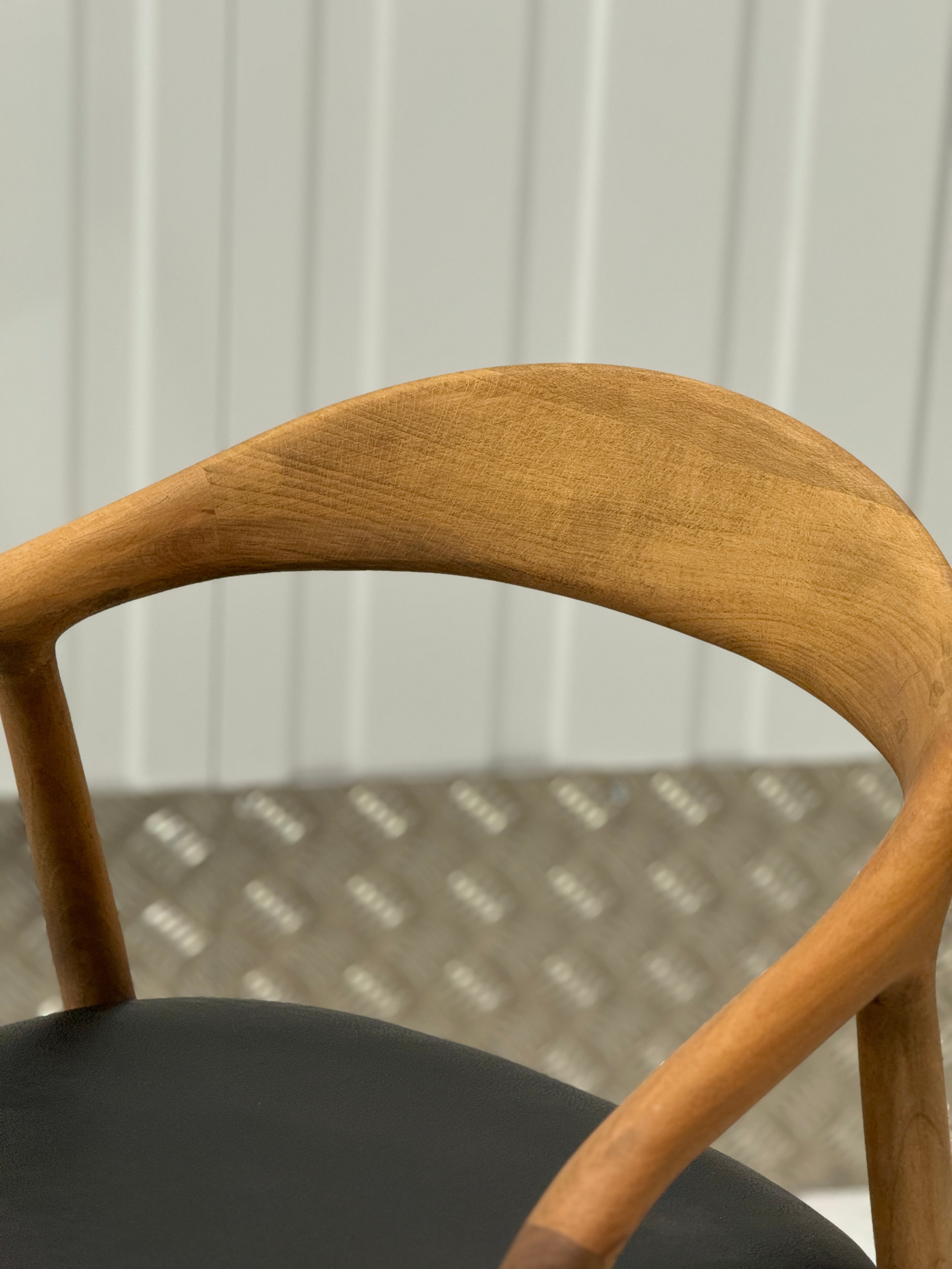 N-Chair by BEDÚ Atelier with a solid oak frame and ergonomic curved backrest, blending style and comfort seamlessly.