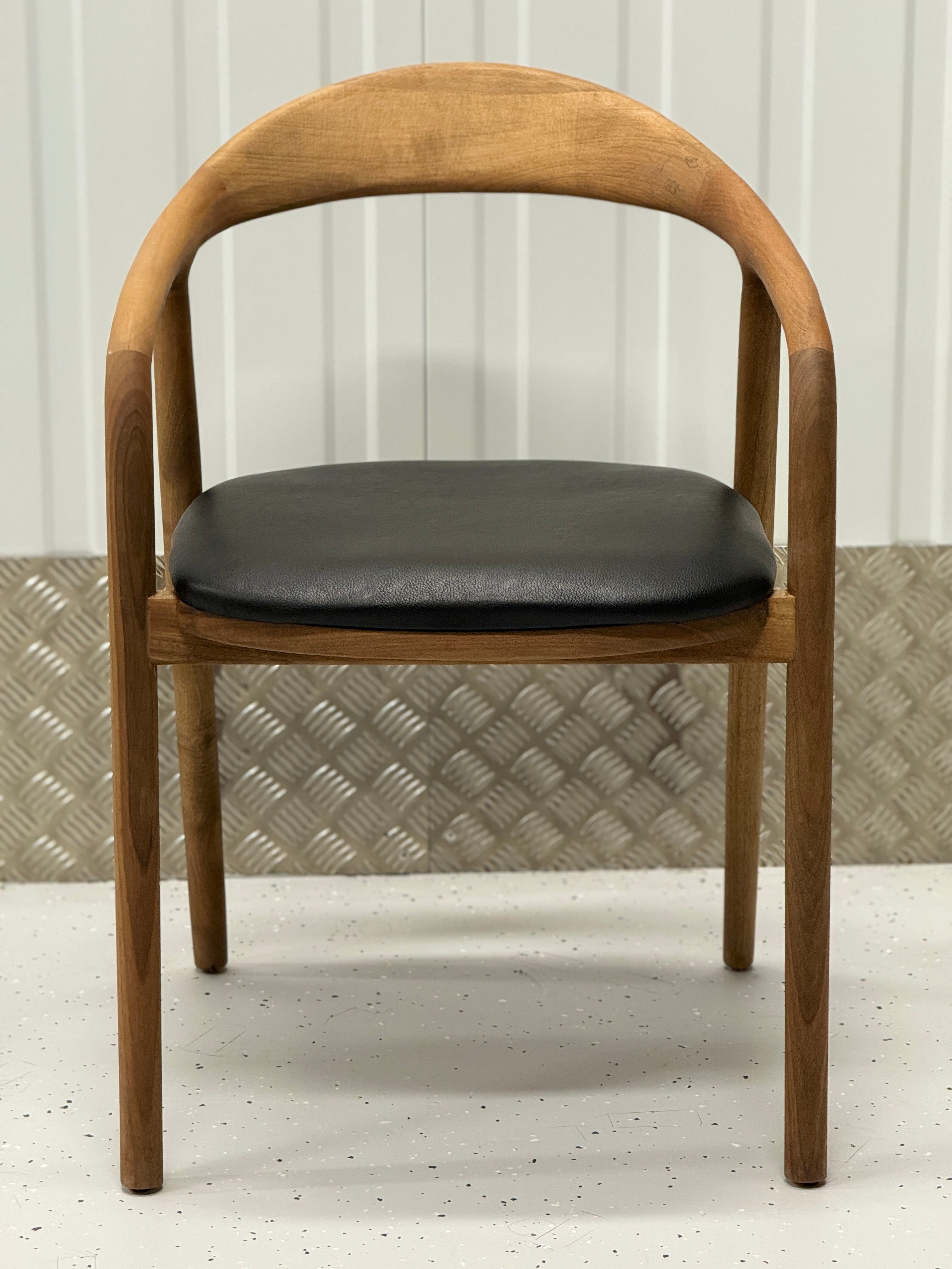 N-Chair featuring a solid oak structure and curved backrest, offering a blend of comfort, durability, and modern design.