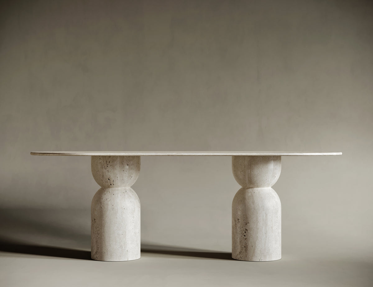 Close-up of an oval travertine tabletop, highlighting its smooth, honed finish and natural stone texture. The light beige surface exudes organic beauty, making it a centerpiece for sophisticated interiors.