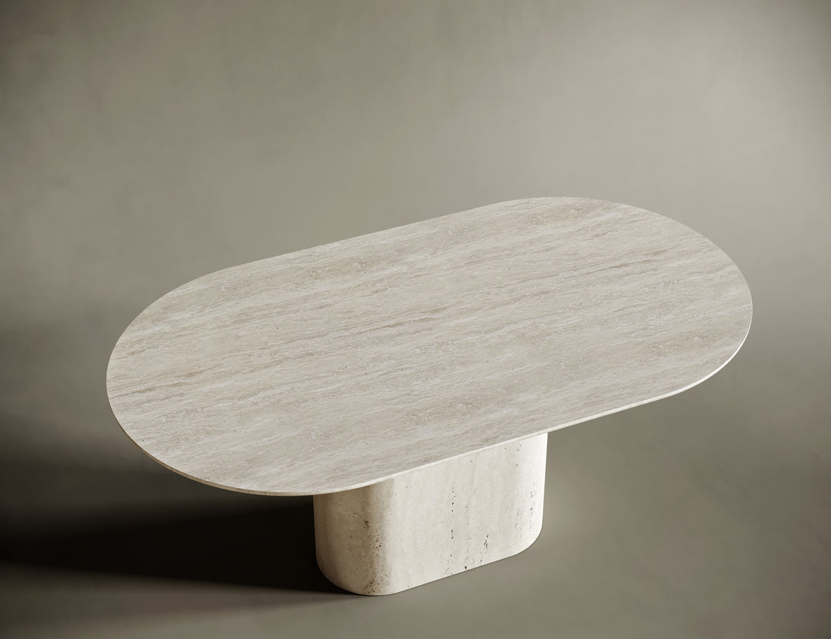 Close-up of an oval travertine tabletop, highlighting its natural stone texture, subtle veining, and honed finish. The light beige surface exudes organic beauty and craftsmanship, making it a perfect centerpiece for modern and minimalist interiors.