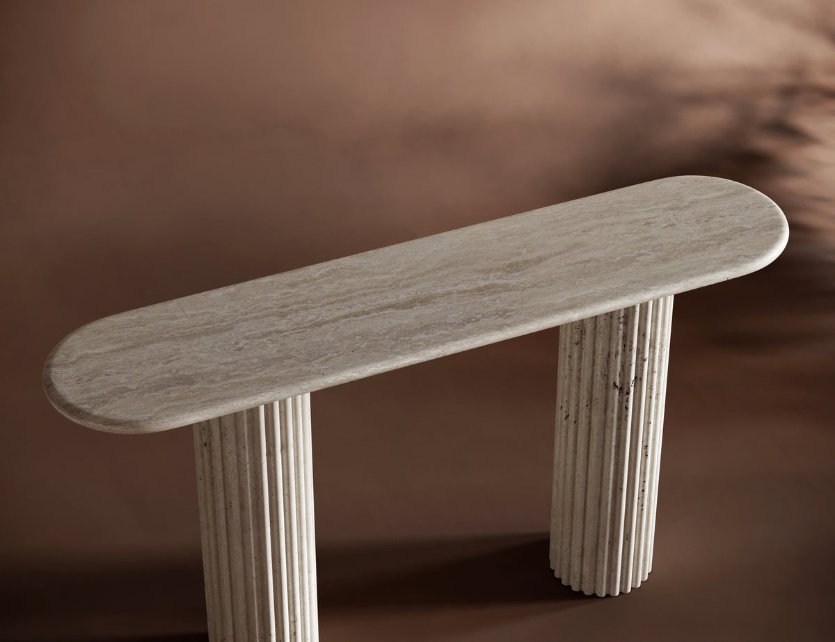 Handcrafted travertine console table with an oval top and fluted legs, perfect for luxury interiors.