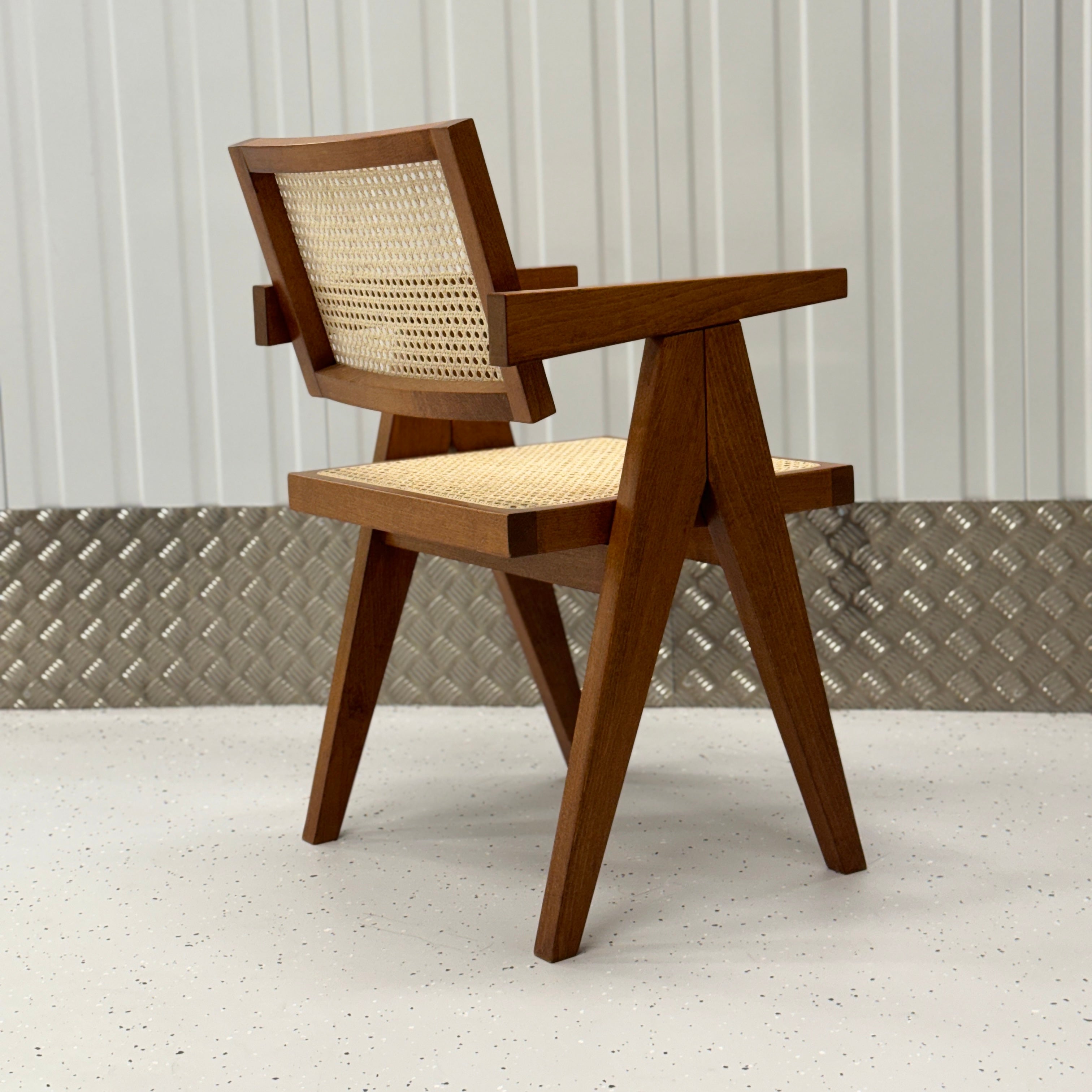 Handcrafted dining chair with a natural rattan seat and backrest, paired with a durable solid wood frame for timeless elegance.