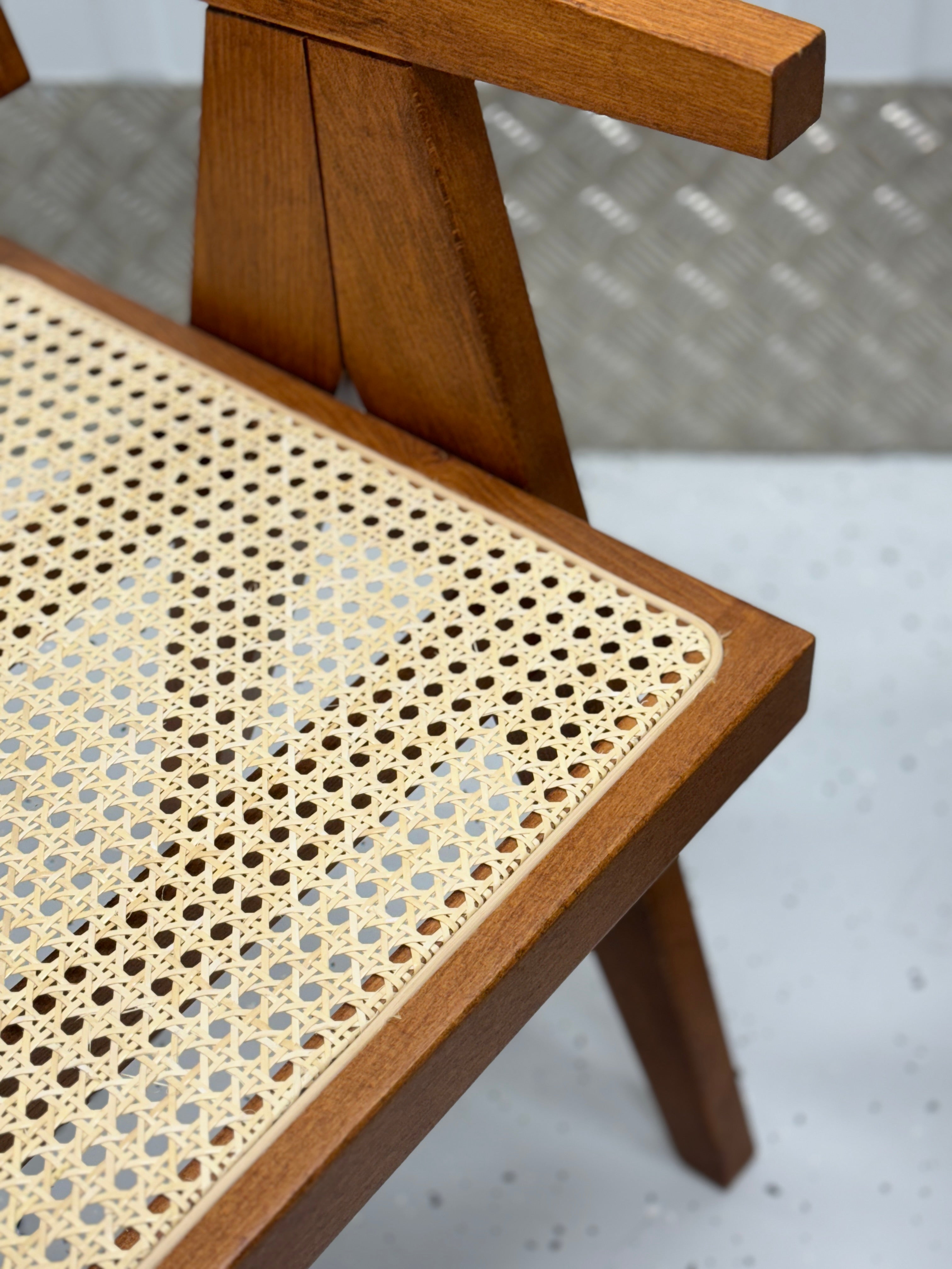 Pierre Dining Chair showcasing intricate rattan weaving and a sturdy wooden frame, perfect for enhancing dining spaces.
