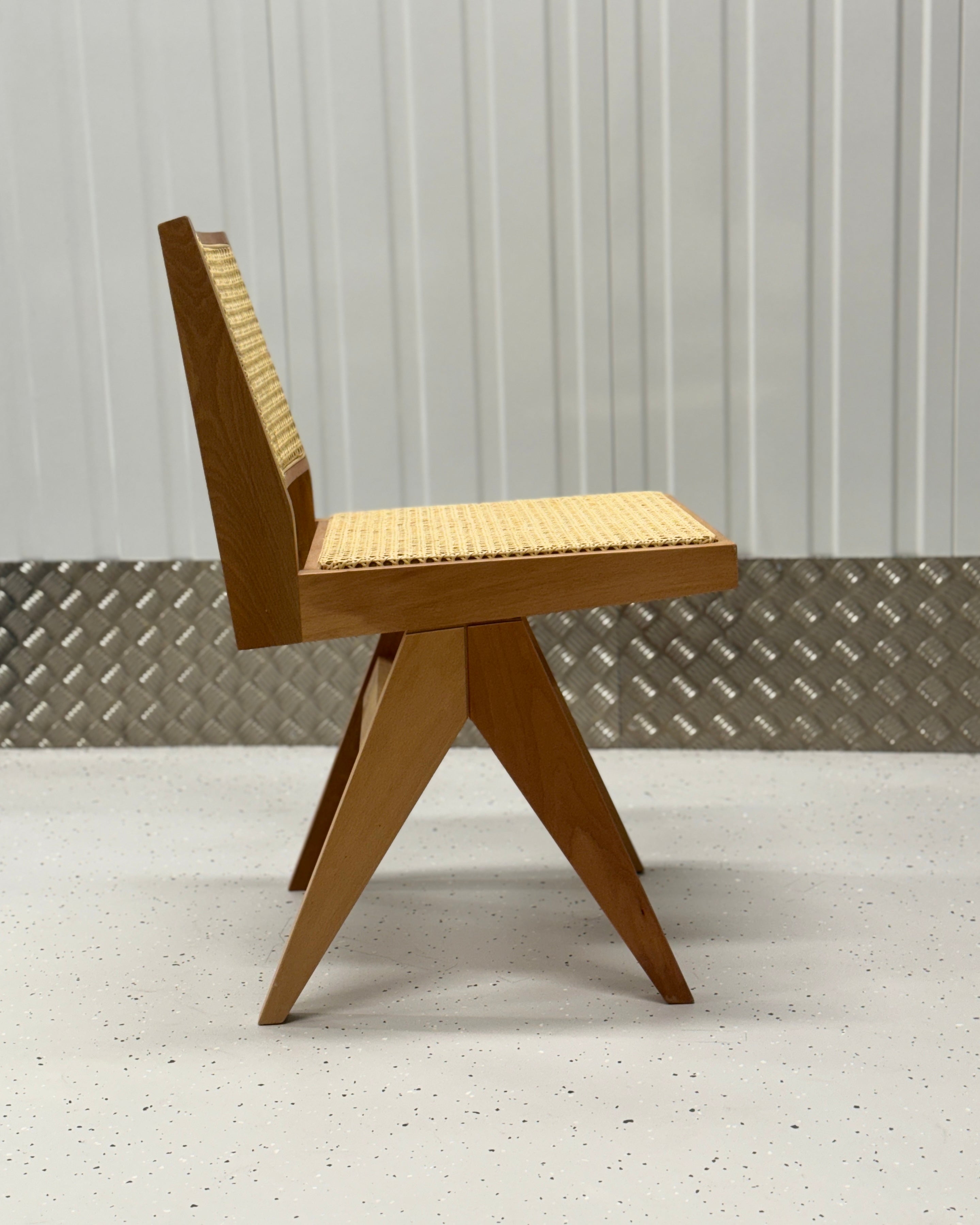 Elegant Pierre Light Chair with a durable solid wood frame and woven rattan backrest, perfect for enhancing dining spaces with a natural touch.