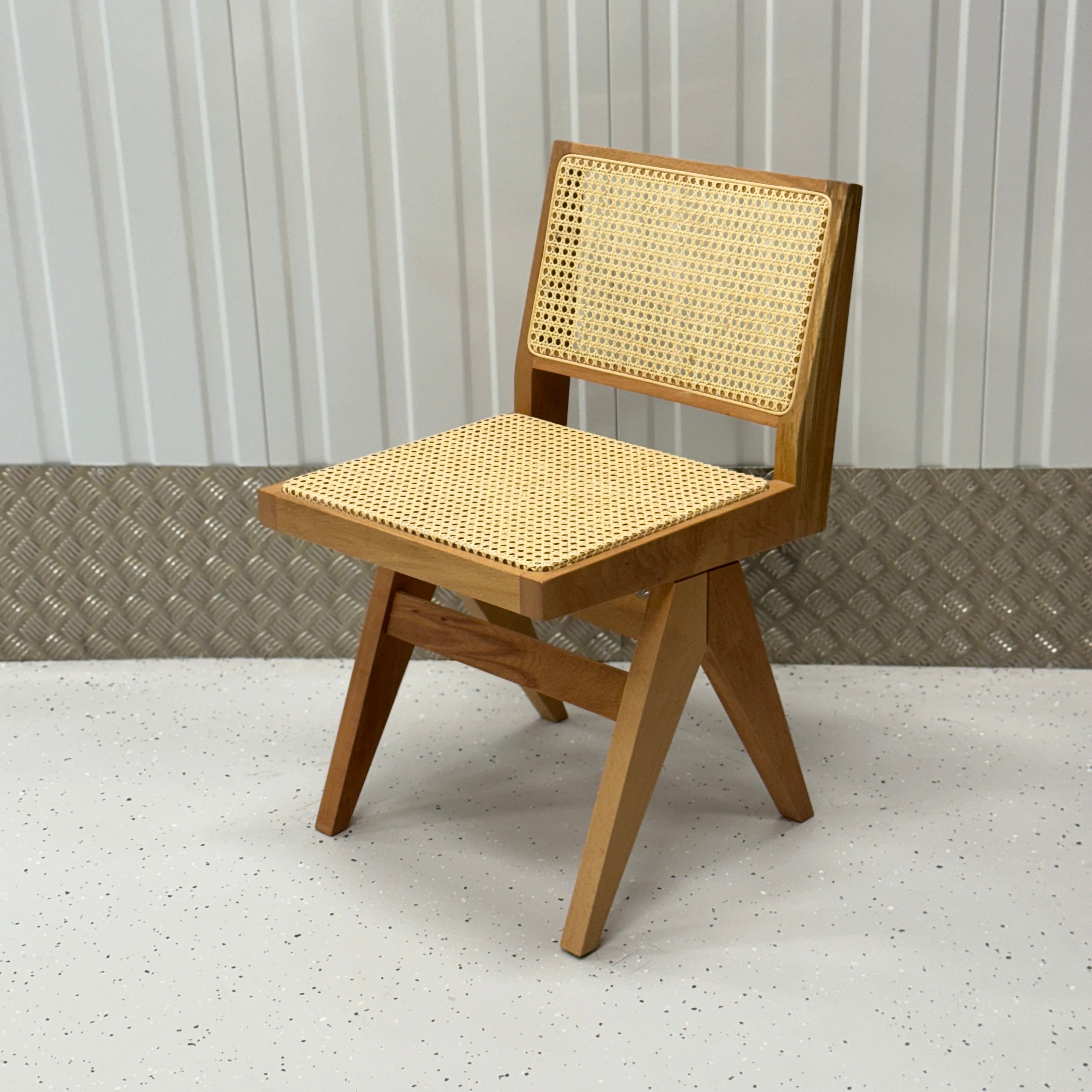 Pierre Light Chair by BEDÚ Atelier, featuring a lightweight solid wood frame and intricate rattan caning, inspired by Pierre Jeanneret’s timeless design.