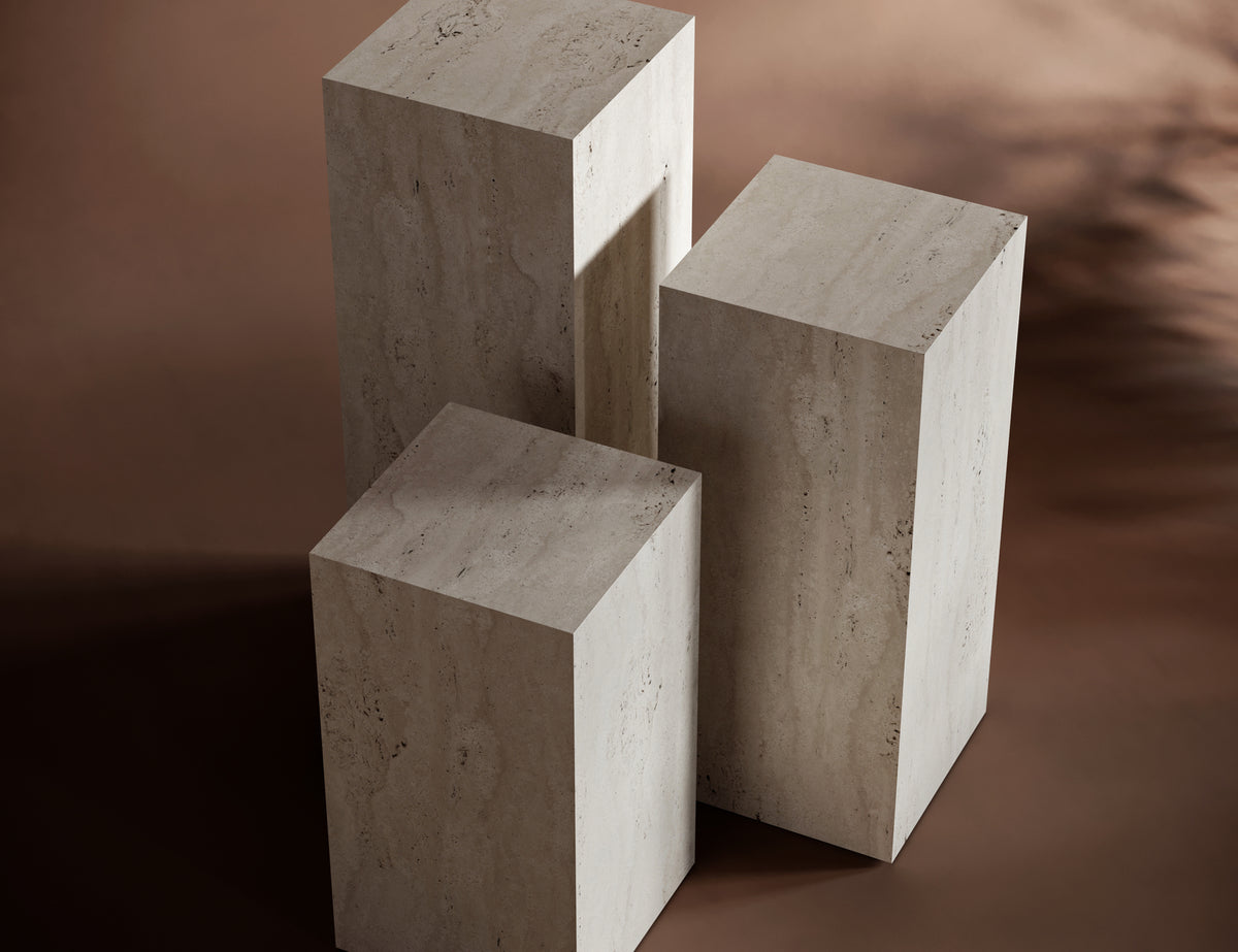 Minimalist interior featuring a travertine pedestal table by Bedu Atelier.