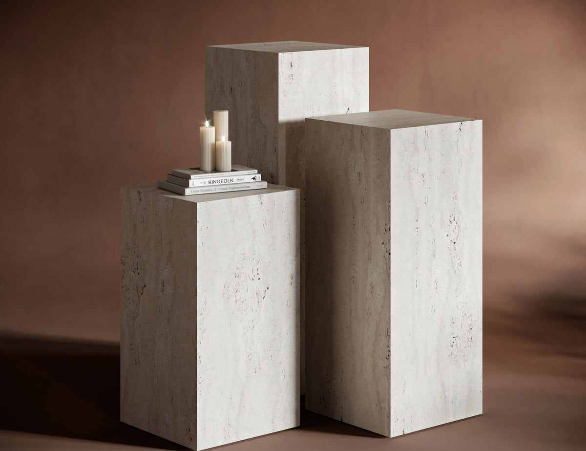 Close-up of travertine pedestal stand with natural stone veining.
