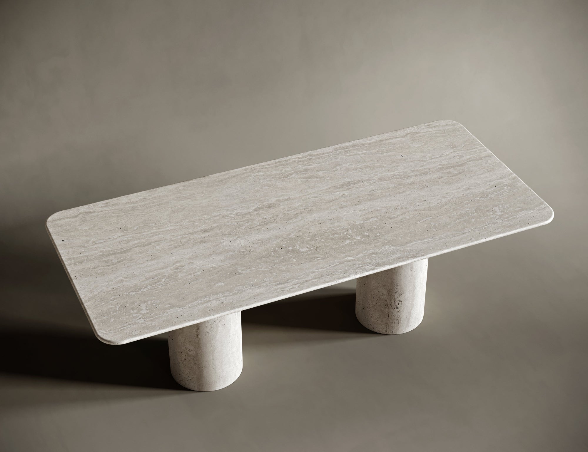 Natural light reflecting off smooth travertine grain on tabletop and leg.