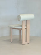 "Minimalist Roll Chair with a cushioned cylindrical backrest, blending natural wood and refined design by BEDÚ Atelier."