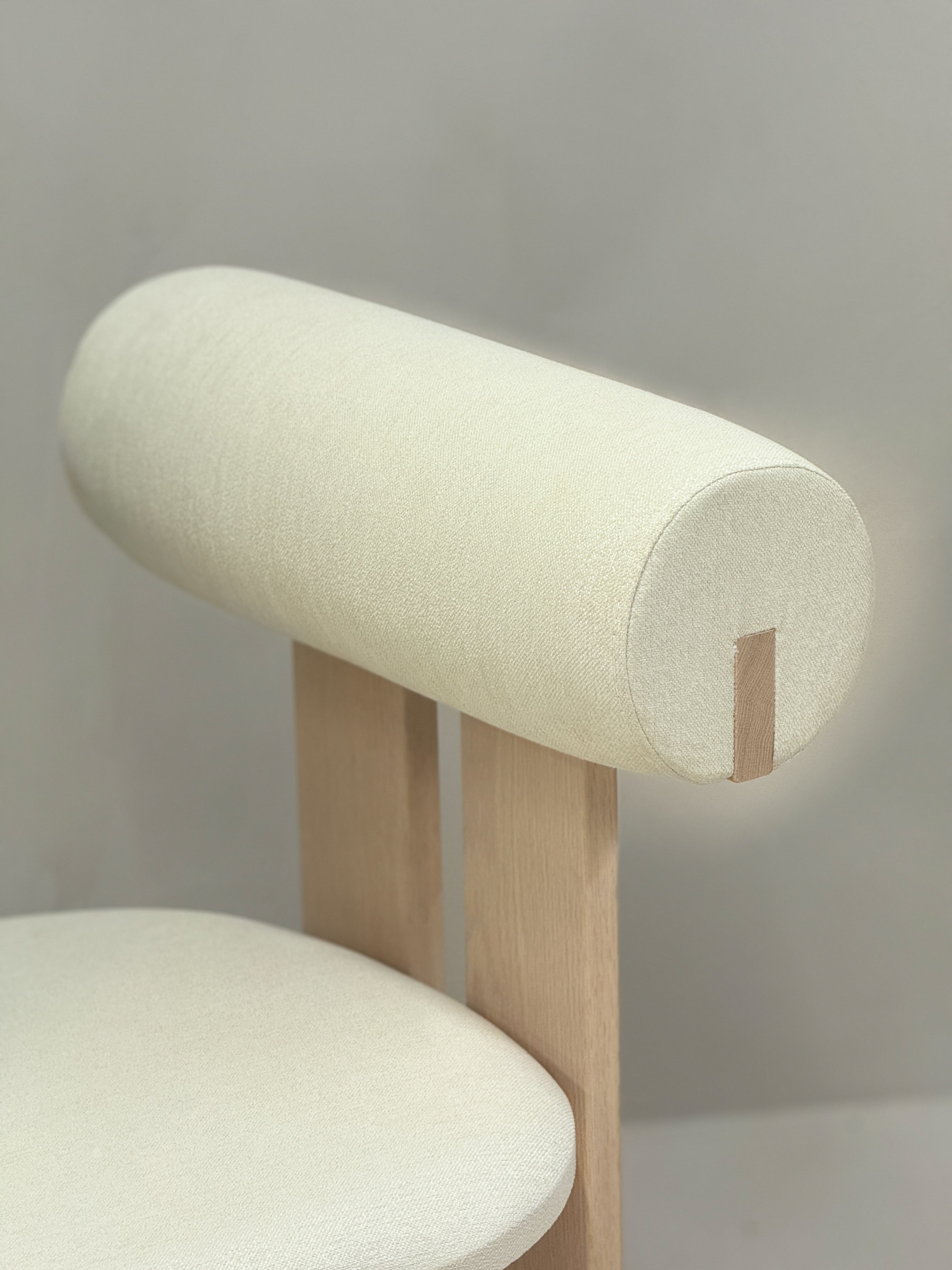 "Modern Roll Chair by BEDÚ Atelier, combining natural materials and sleek craftsmanship for a timeless dining experience."