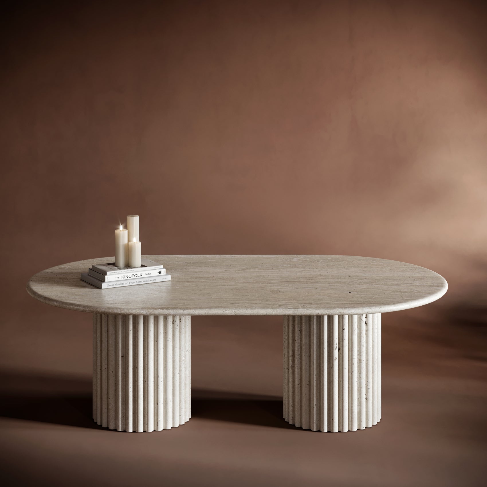 SERENA travertine coffee table with an oval top and fluted cylindrical bases, showcasing natural stone textures.