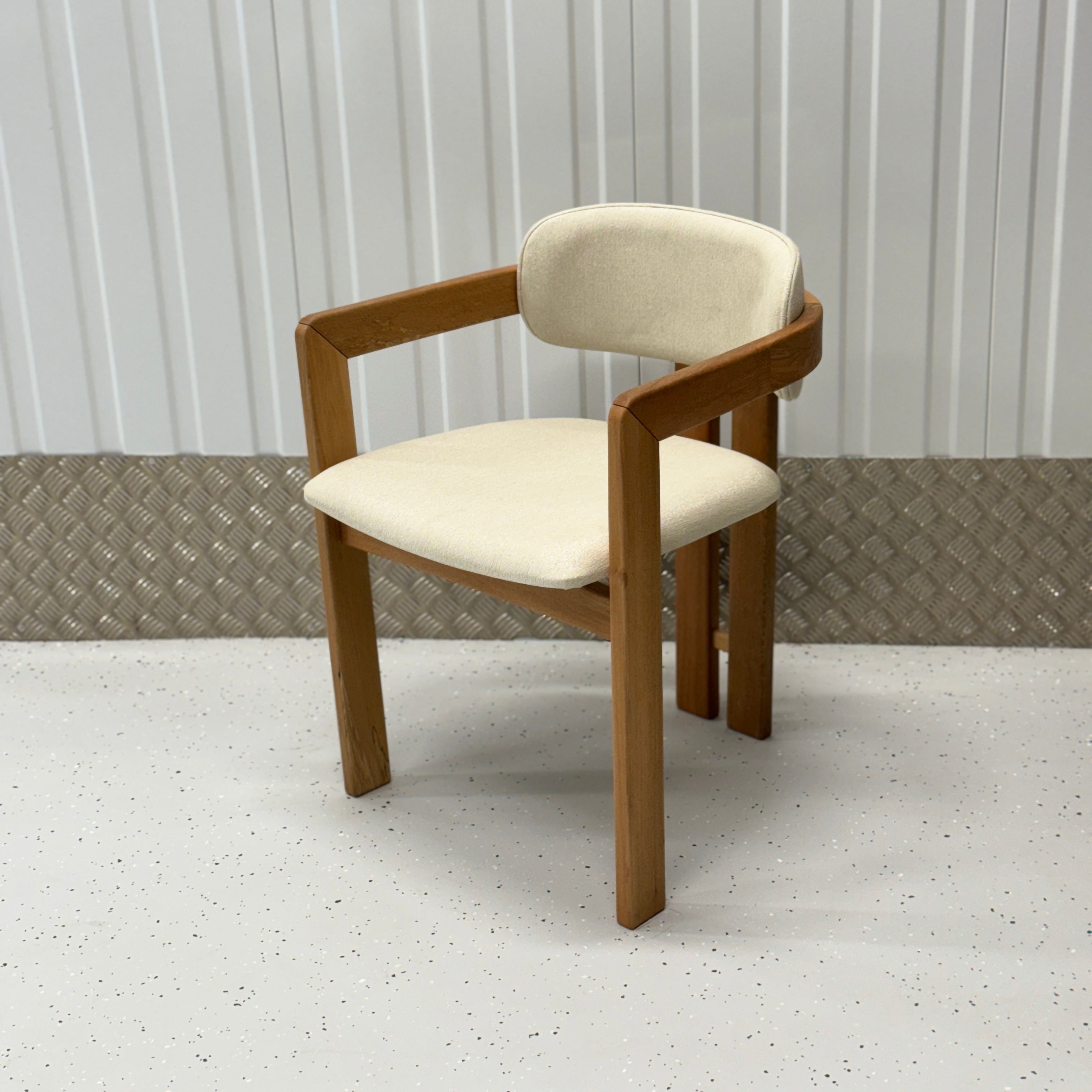 Luxury Mid-Century Modern dining chair with a wooden frame and fabric upholstery, designed by BEDÚ Atelier