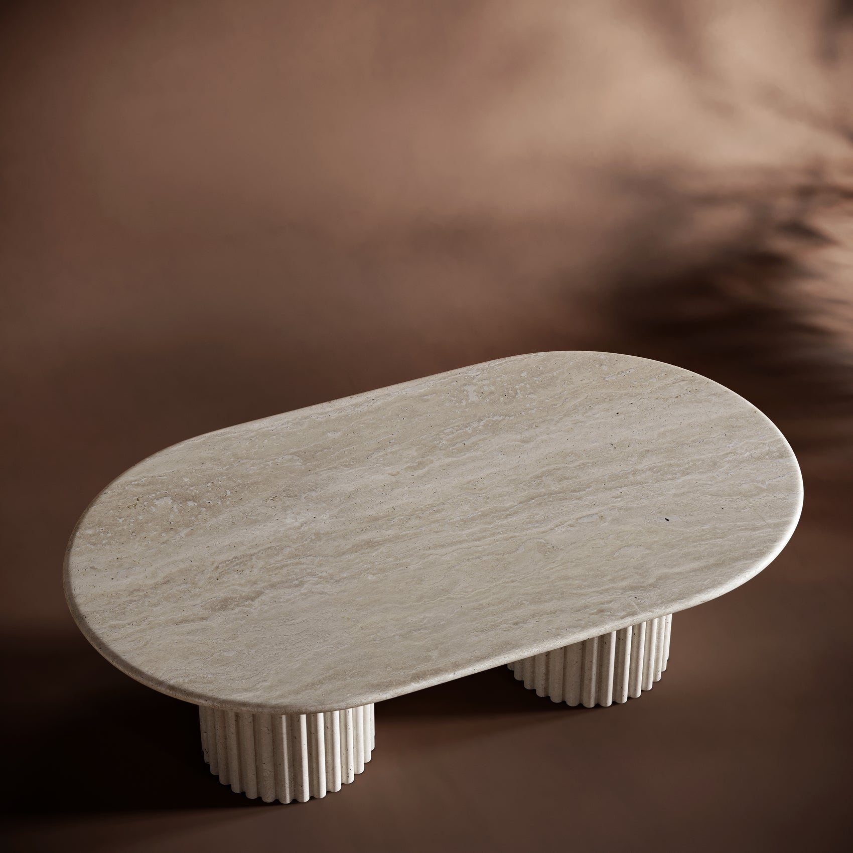 Handcrafted travertine coffee table with fluted bases and a smooth, elegant tabletop.

