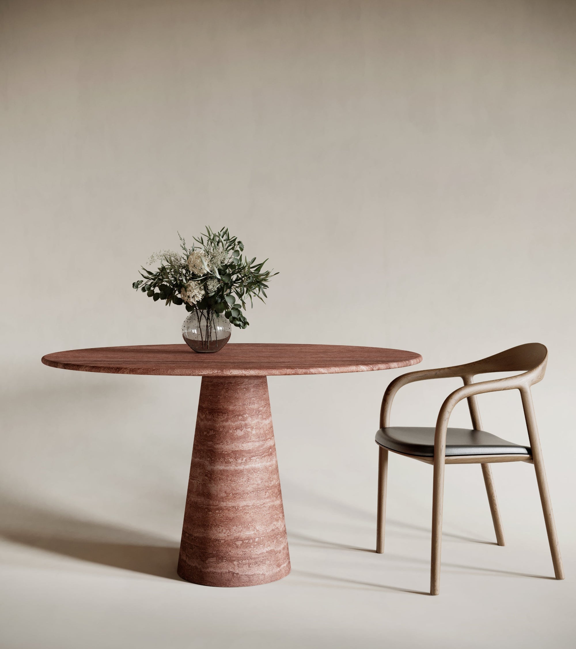 Bold round red travertine dining table with conical leg, warm-toned natural stone finish, striking sculptural centerpiece, modern travertin design, perfect for statement dining