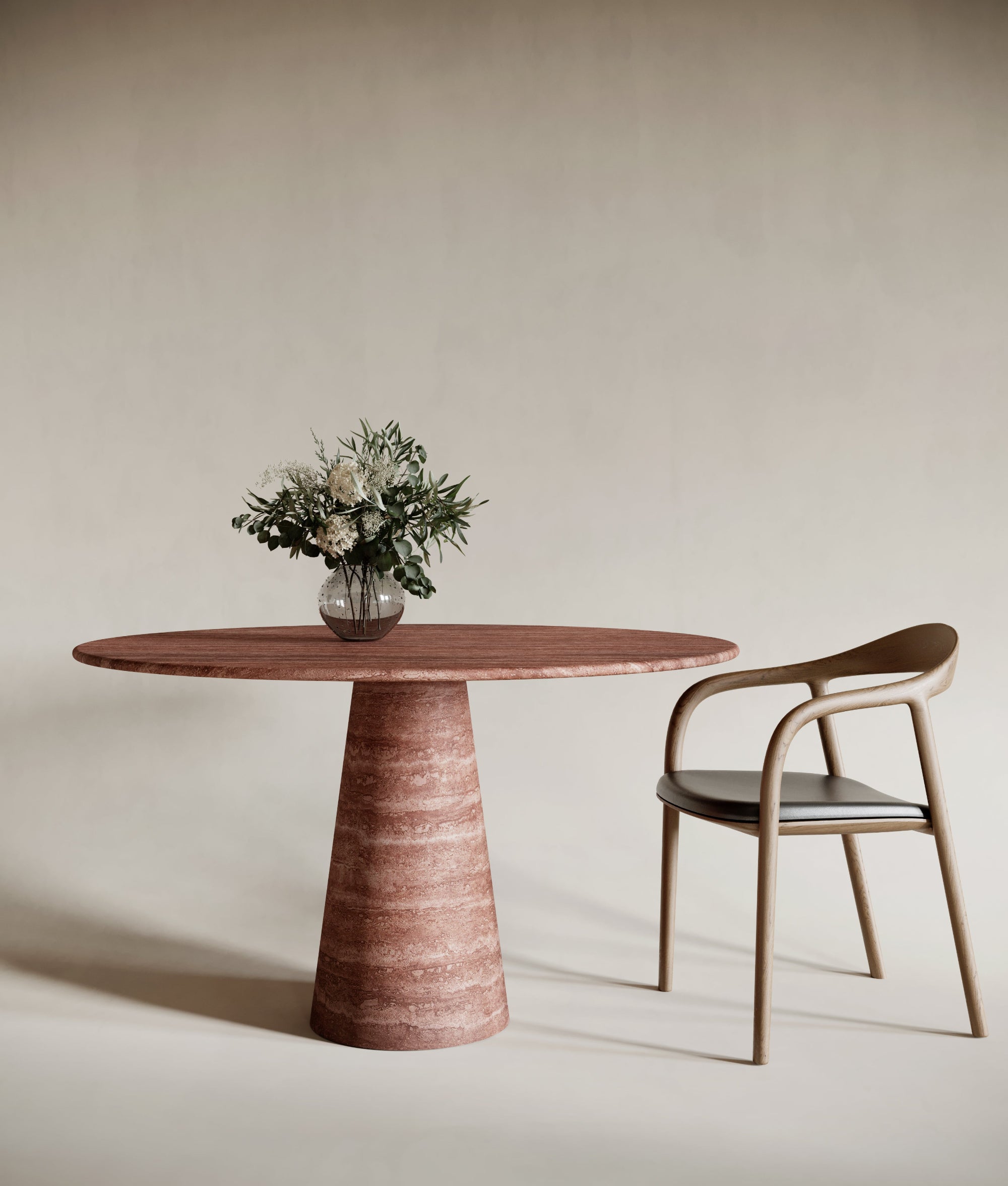 Bold round red travertine dining table with conical leg, warm-toned natural stone finish, striking sculptural centerpiece, modern travertin design, perfect for statement dining