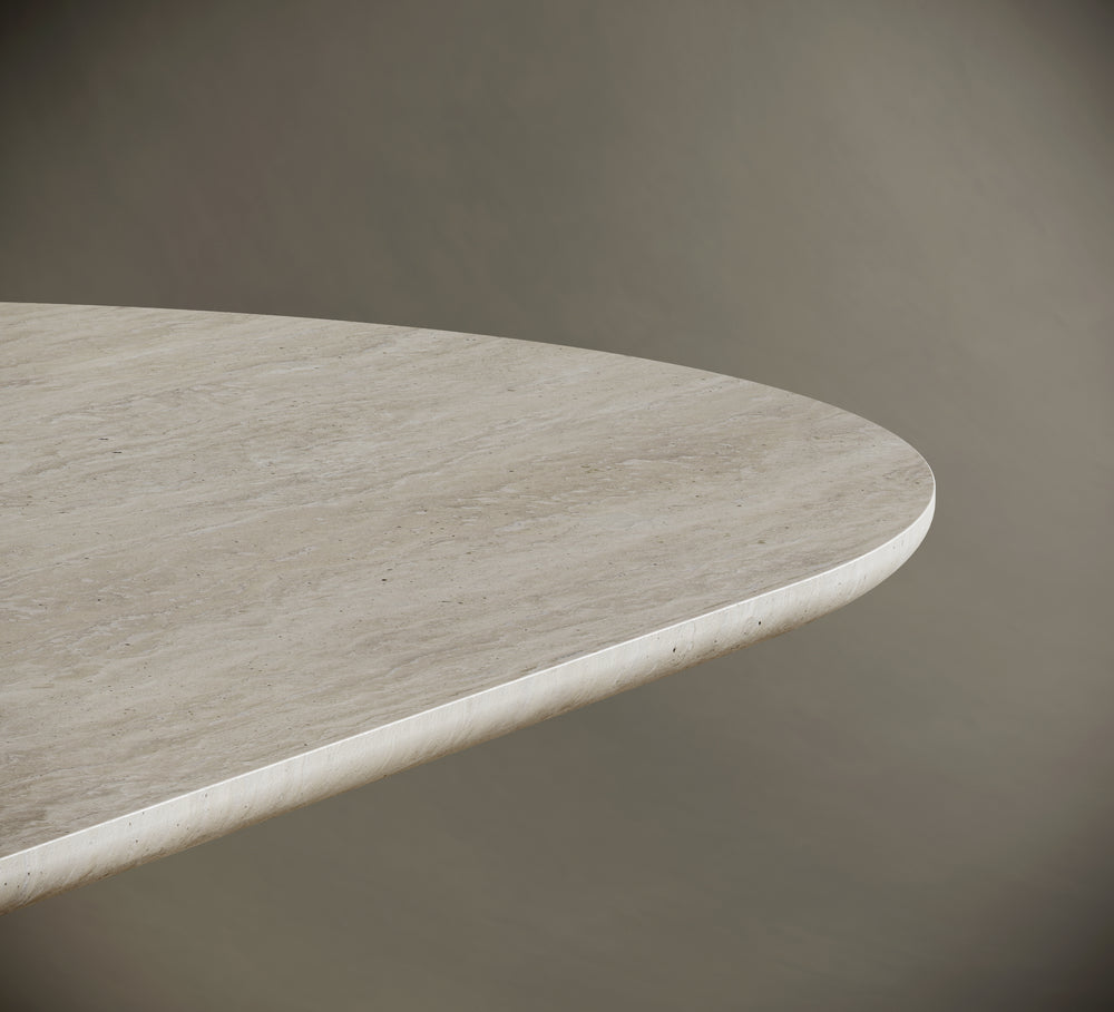 Detailed close-up of a travertine tabletop, highlighting its rounded edge and natural stone texture with subtle veining. The light beige surface features a honed finish, showcasing the craftsmanship and organic beauty of the material. Perfect for modern, minimalist interiors and luxury furniture design