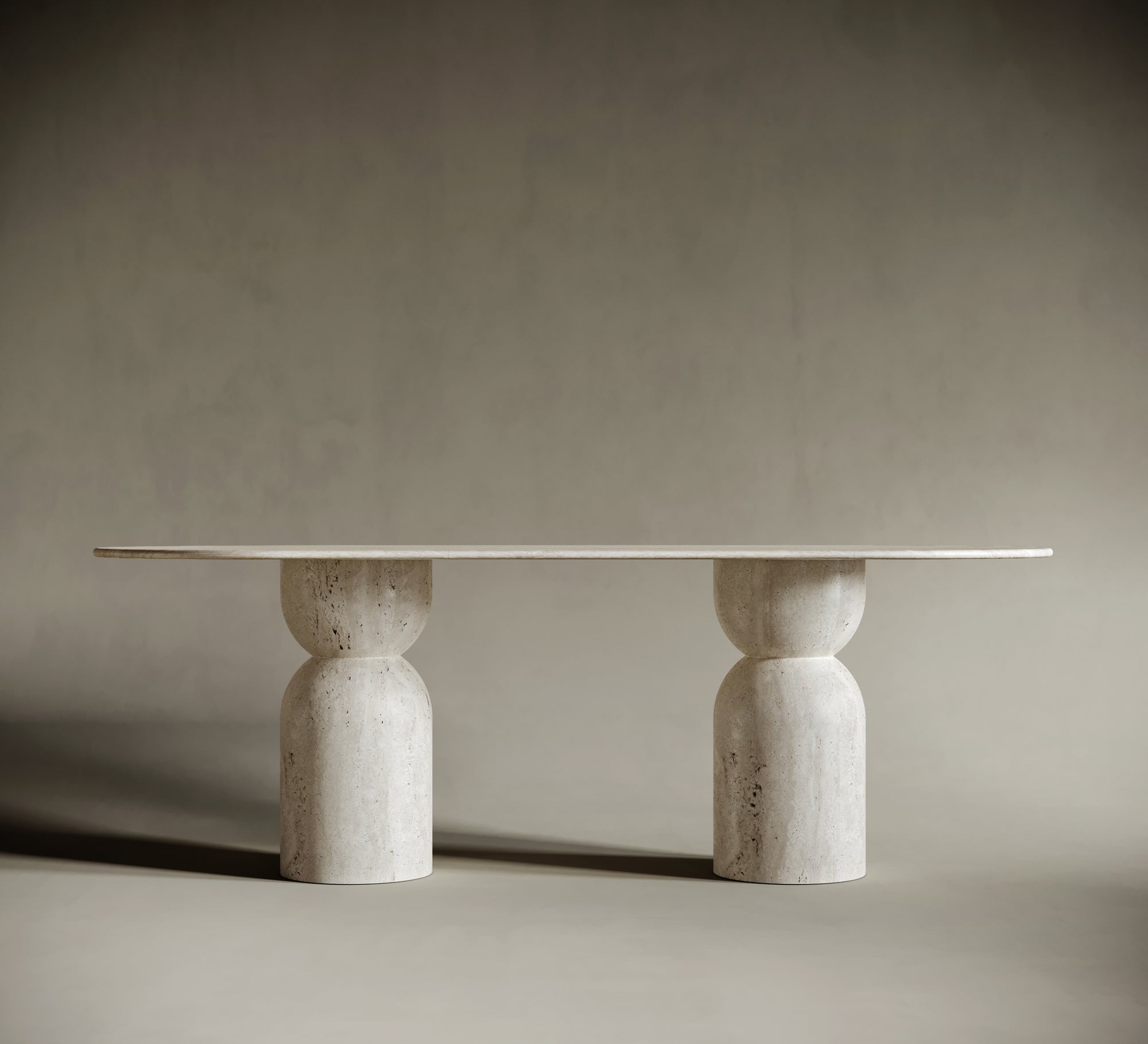 Close-up of an oval travertine tabletop, highlighting its smooth, honed finish and natural stone texture. The light beige surface exudes organic beauty, making it a centerpiece for sophisticated interiors.