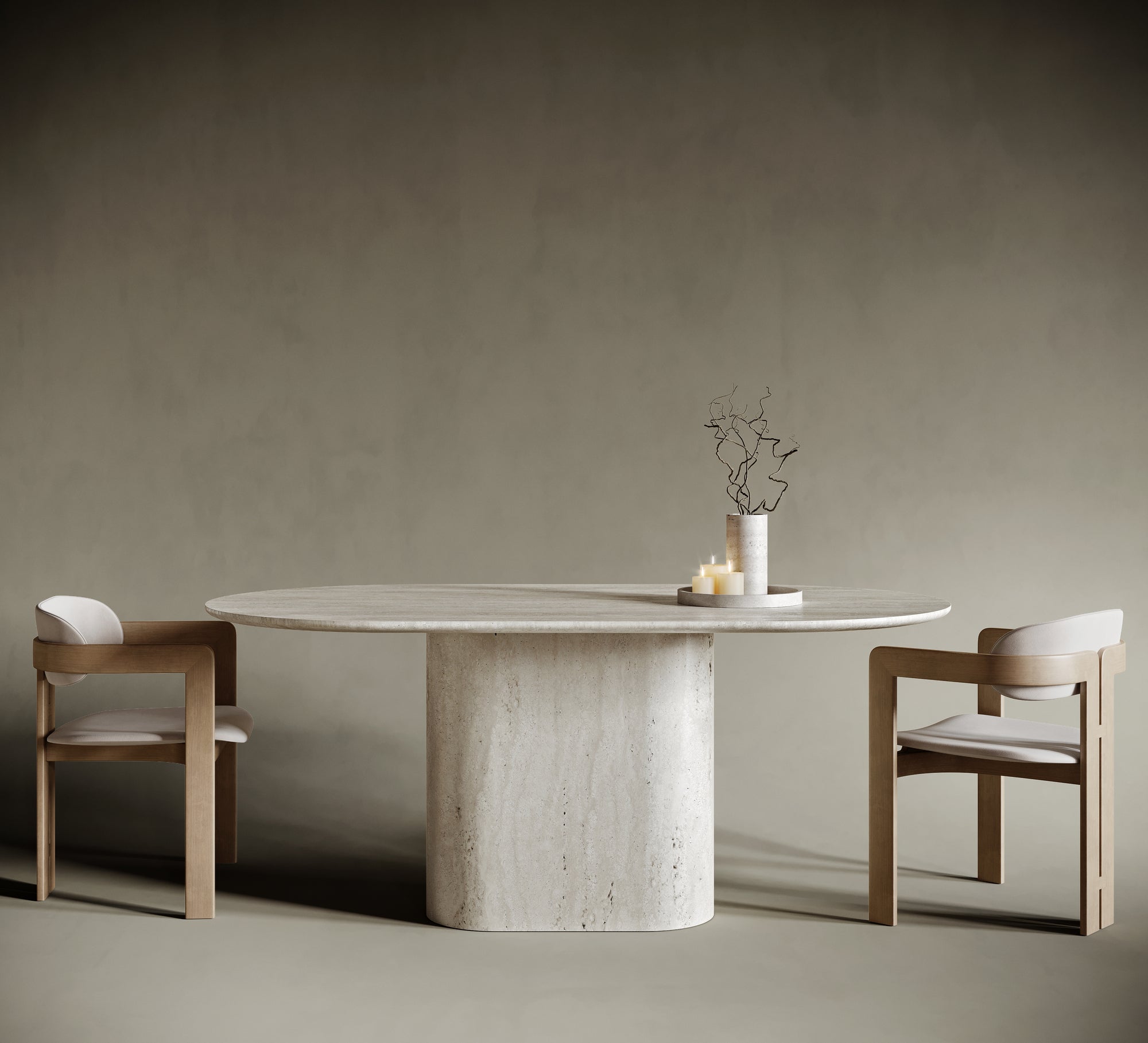 Minimalist dining room featuring an oval travertine dining table with a sculptural single pedestal base. Paired with two modern wooden chairs upholstered in light beige fabric, the table showcases natural stone textures and timeless design. Set against a muted olive-beige background, this serene interior highlights luxury craftsmanship and contemporary elegance.