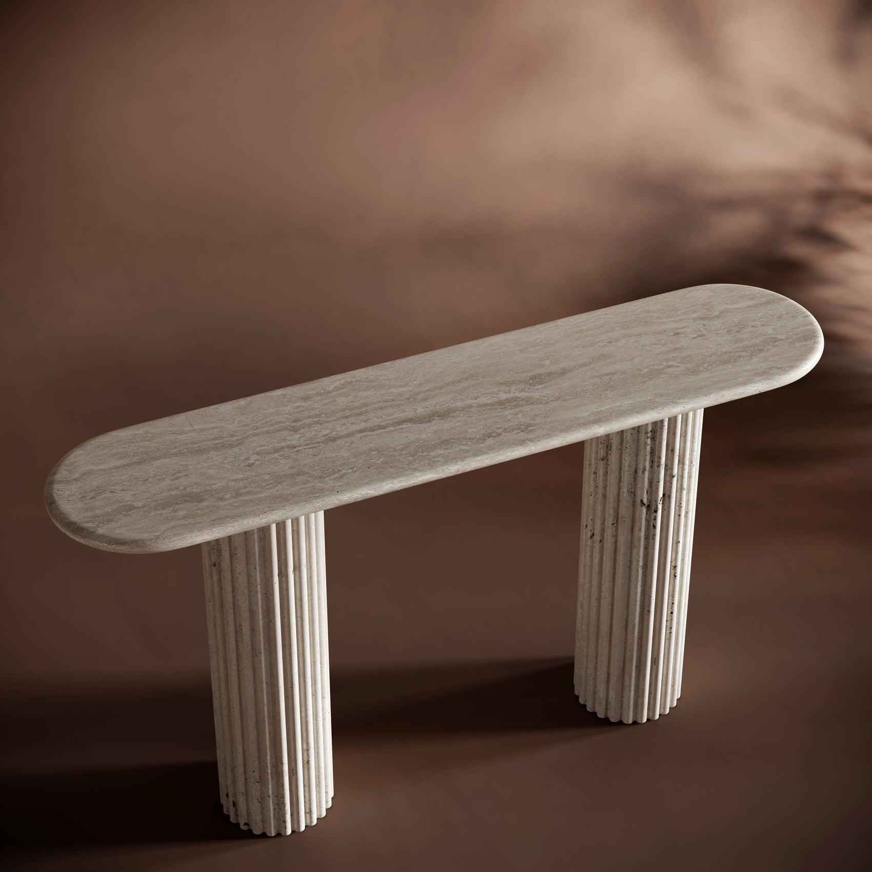 Handcrafted travertine console table with an oval top and fluted legs, perfect for luxury interiors.
