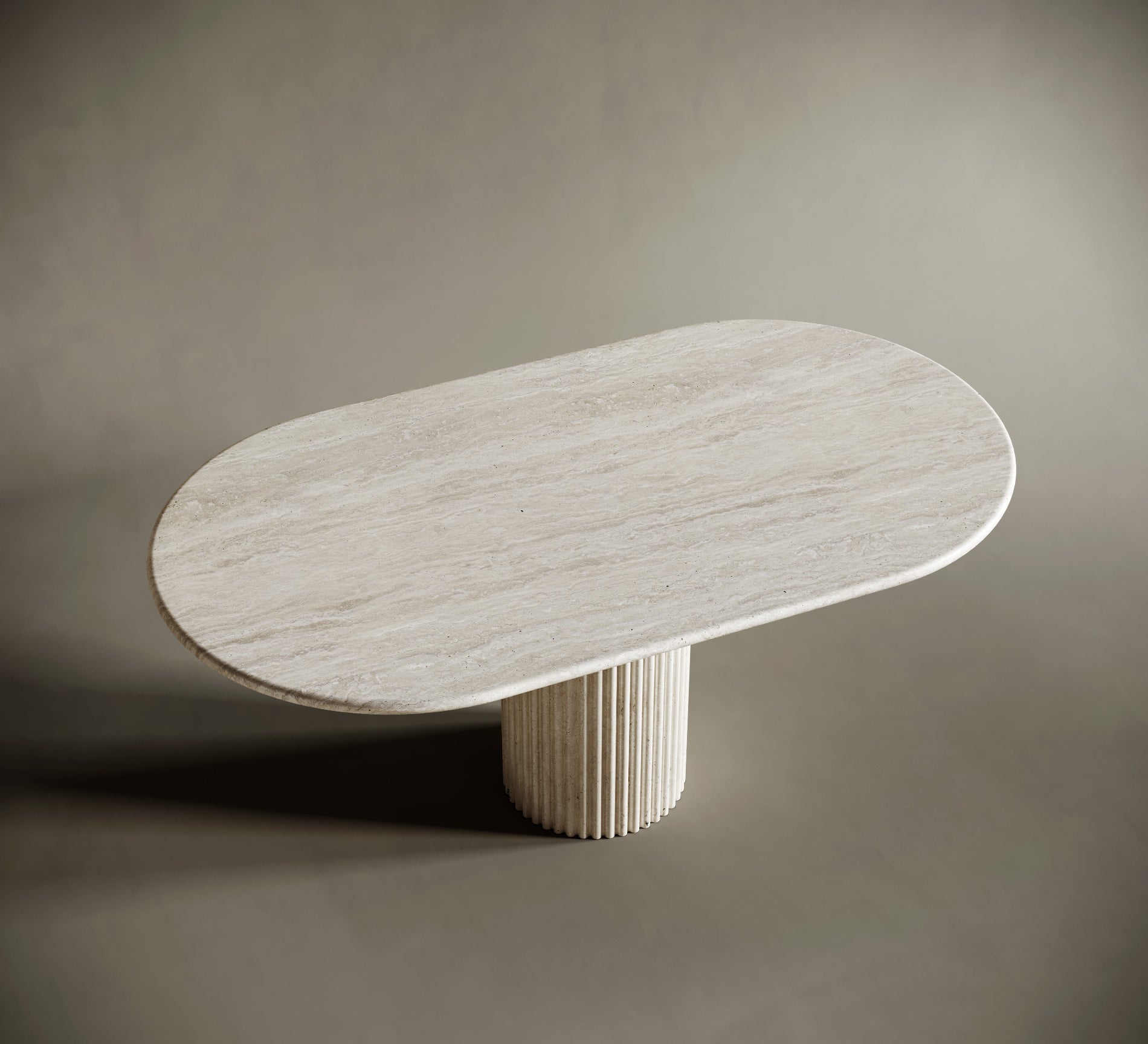 Modern oval travertine table with fluted base on a neutral background