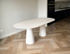 Marble dining table in a modern kitchen with wooden flooring