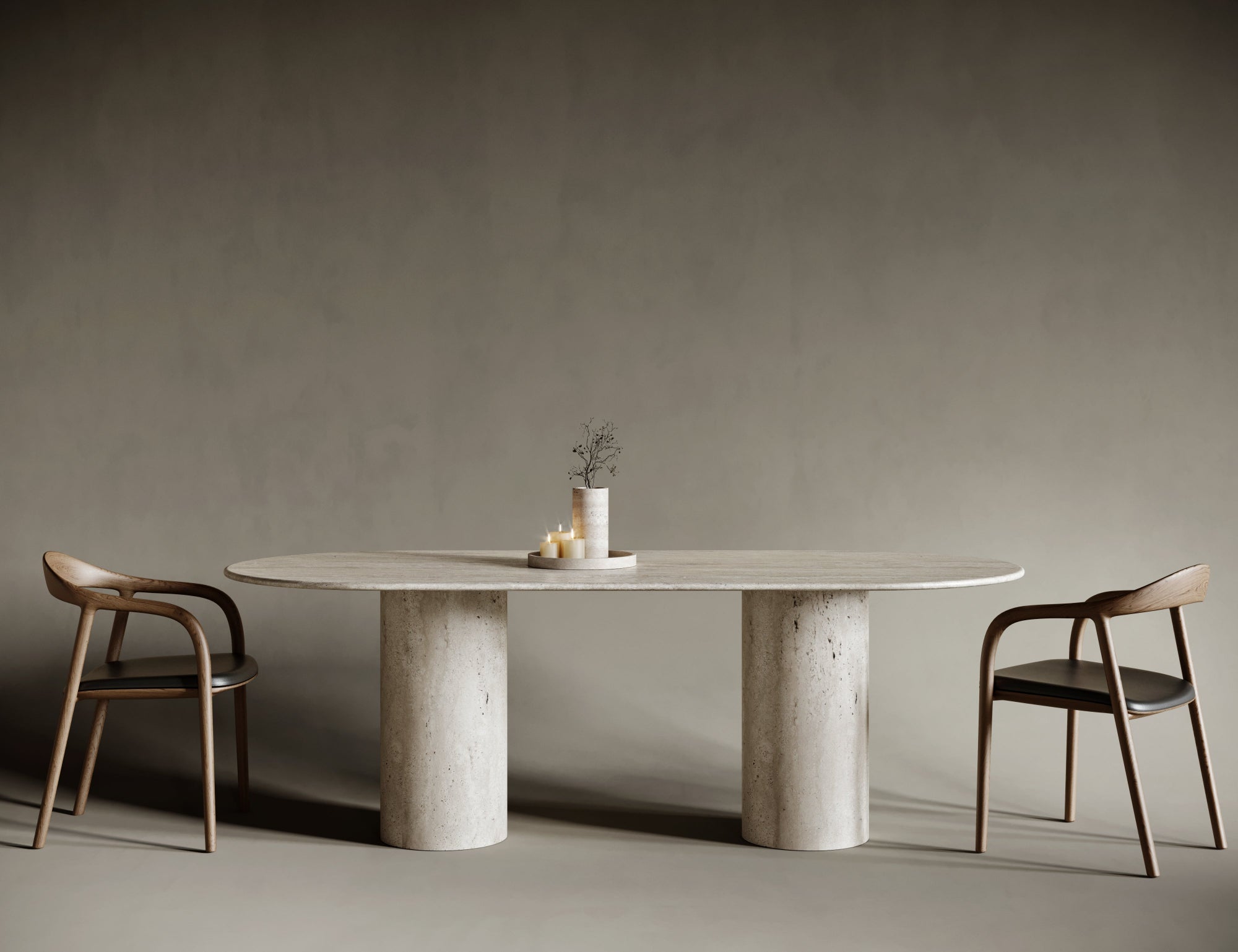 Elegant oval travertine dining table supported by a single cylindrical leg, combining fluid curved lines with the solidity of natural stone; ideal for sophisticated dining rooms where form meets function with architectural clarity