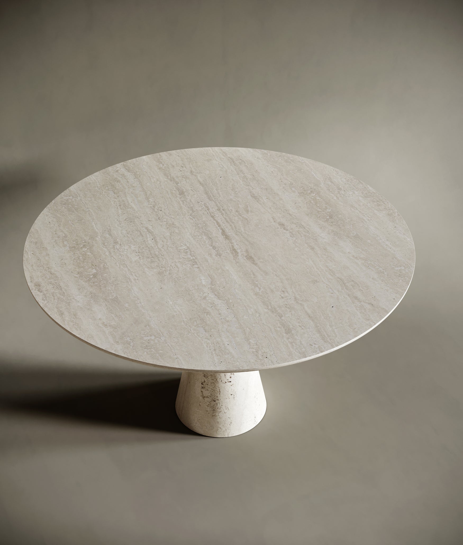 Detailed view of the travertine  round dining table, showcasing its sculptural form and smooth, natural stone texture. The elegant design balances functionality with artistic expression, ideal for modern and minimalist spaces