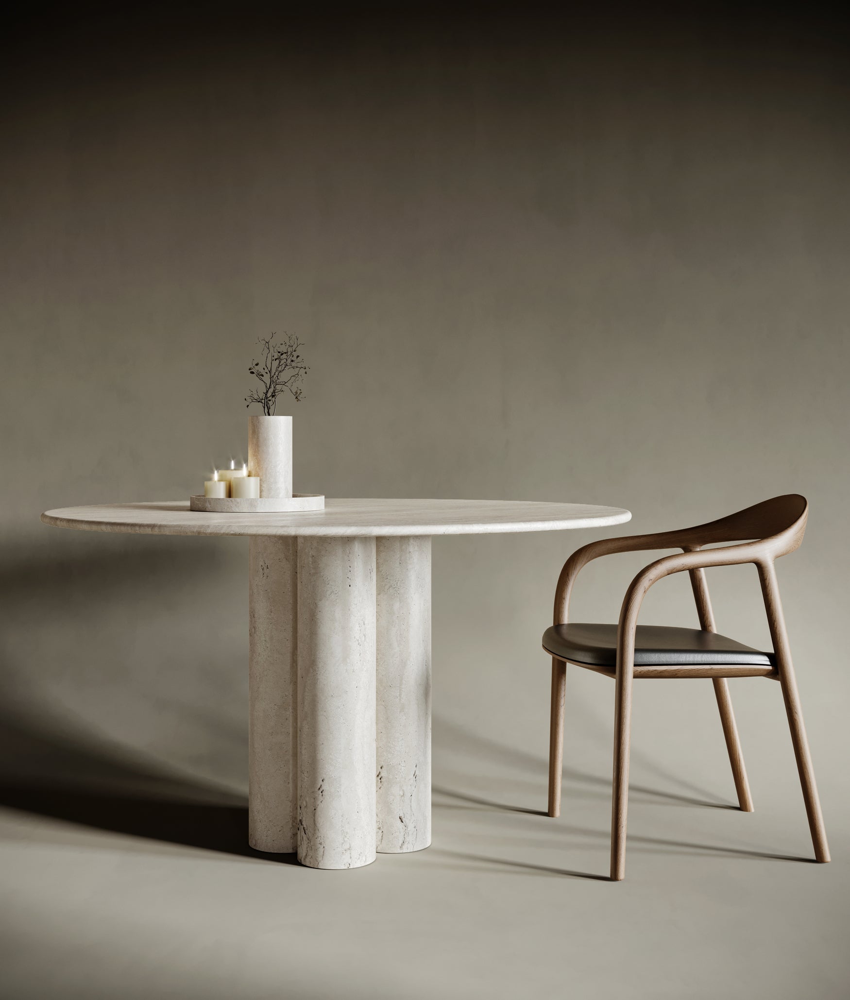 Elegant dining room featuring a round travertine dining table with four cylindrical legs. The natural stone surface showcases unique textures and organic patterns, creating a harmonious blend of modern design and timeless craftsmanship.